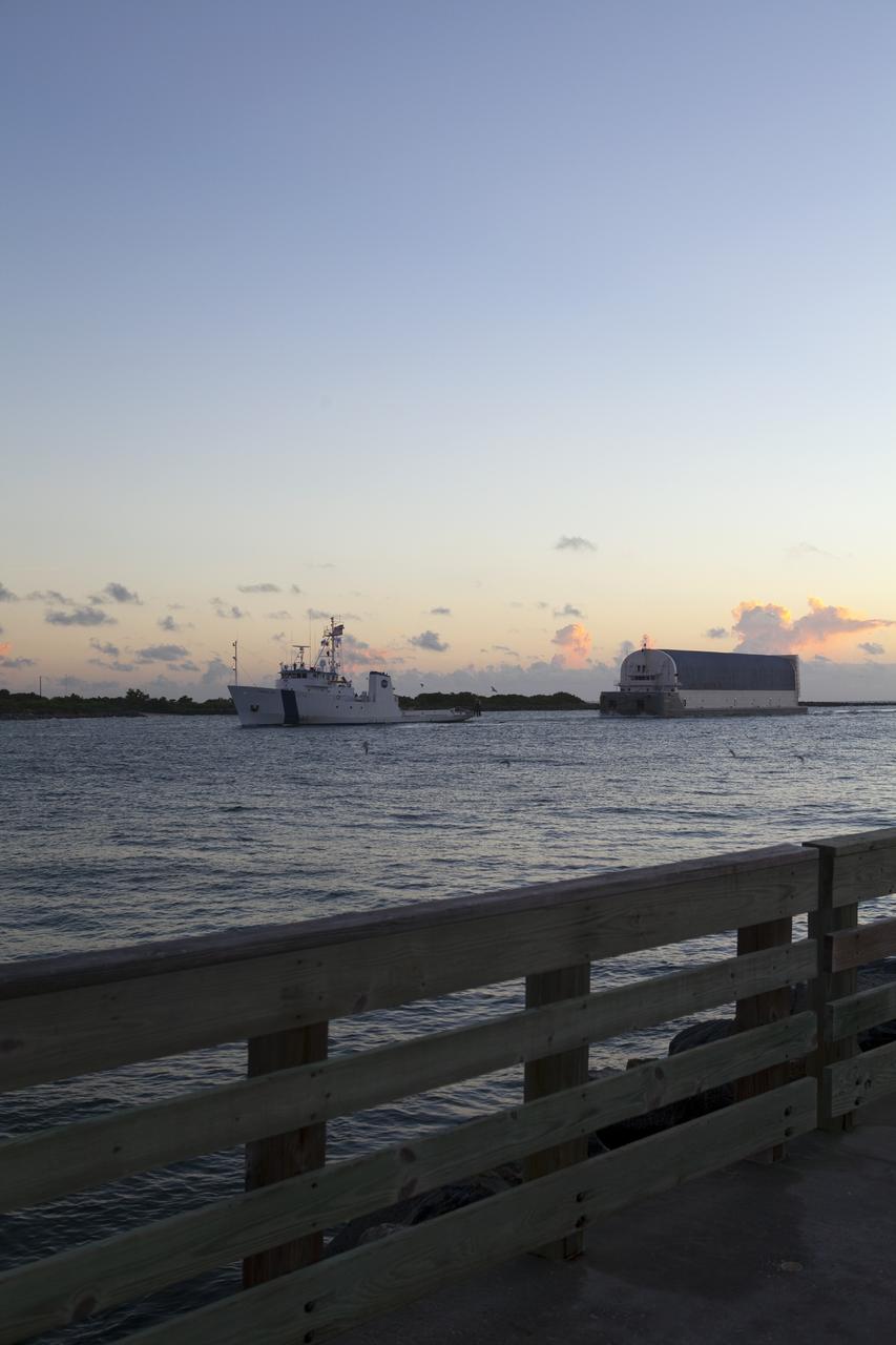 CAPE CANAVERAL, Fla. -- Freedom Star, one of NASA's solid rocket booster retrieval ships, ushers the Space Shuttle Program's last external fuel tank, ET-122, toward NASA's Kennedy Space Center in Florida. The tank traveled 900 miles by sea from NASA's Michoud Assembly Facility in New Orleans aboard the Pegasus Barge. After reaching the Turn Basin at Kennedy, the tank will be offloaded and moved to the Vehicle Assembly Building where it eventually will be attached to space shuttle Endeavour for the STS-134 mission to the International Space Station. STS-134, targeted to launch in Feb. 2011, currently is scheduled to be the last mission in the Space Shuttle Program.        The tank, which is the largest element of the space shuttle stack, was damaged during Hurricane Katrina in August 2005 and restored to flight configuration by Lockheed Martin Space Systems Company employees. Photo credit: NASA/Frankie Martin