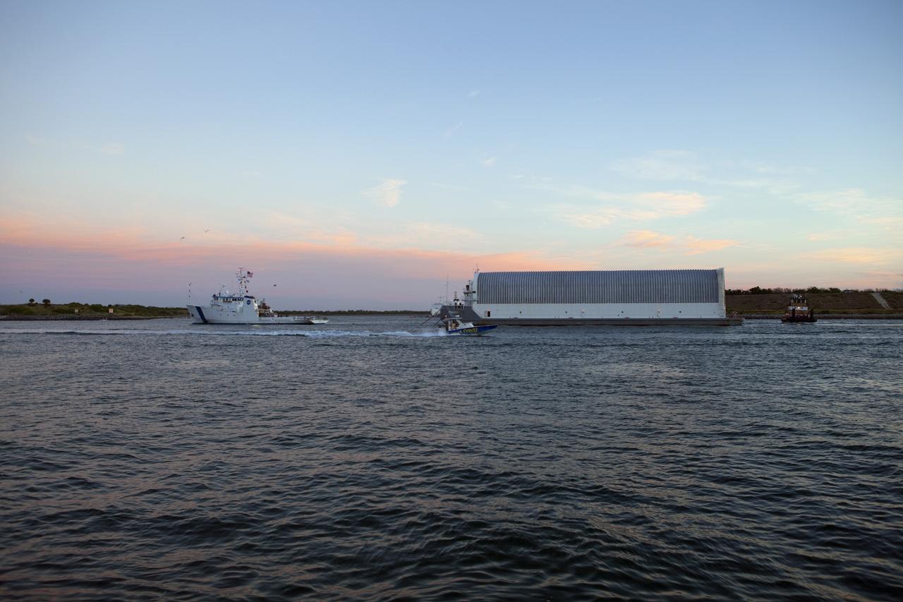 CAPE CANAVERAL, Fla. -- Freedom Star, one of NASA's solid rocket booster retrieval ships, ushers the Space Shuttle Program's last external fuel tank, ET-122, toward NASA's Kennedy Space Center in Florida. The tank traveled 900 miles by sea from NASA's Michoud Assembly Facility in New Orleans aboard the Pegasus Barge. After reaching the Turn Basin at Kennedy, the tank will be offloaded and moved to the Vehicle Assembly Building where it eventually will be attached to space shuttle Endeavour for the STS-134 mission to the International Space Station. STS-134, targeted to launch in Feb. 2011, currently is scheduled to be the last mission in the Space Shuttle Program.        The tank, which is the largest element of the space shuttle stack, was damaged during Hurricane Katrina in August 2005 and restored to flight configuration by Lockheed Martin Space Systems Company employees. Photo credit: NASA/Frankie Martin