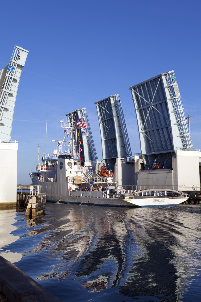 CAPE CANAVERAL, Fla. -- Freedom Star, one of NASA's solid rocket booster retrieval ships, ushers the Space Shuttle Program's last external fuel tank, ET-122, toward NASA's Kennedy Space Center in Florida. The tank traveled 900 miles by sea from NASA's Michoud Assembly Facility in New Orleans aboard the Pegasus Barge. After reaching the Turn Basin at Kennedy, the tank will be offloaded and moved to the Vehicle Assembly Building where it eventually will be attached to space shuttle Endeavour for the STS-134 mission to the International Space Station. STS-134, targeted to launch in Feb. 2011, currently is scheduled to be the last mission in the Space Shuttle Program.        The tank, which is the largest element of the space shuttle stack, was damaged during Hurricane Katrina in August 2005 and restored to flight configuration by Lockheed Martin Space Systems Company employees. Photo credit: NASA/Frankie Martin