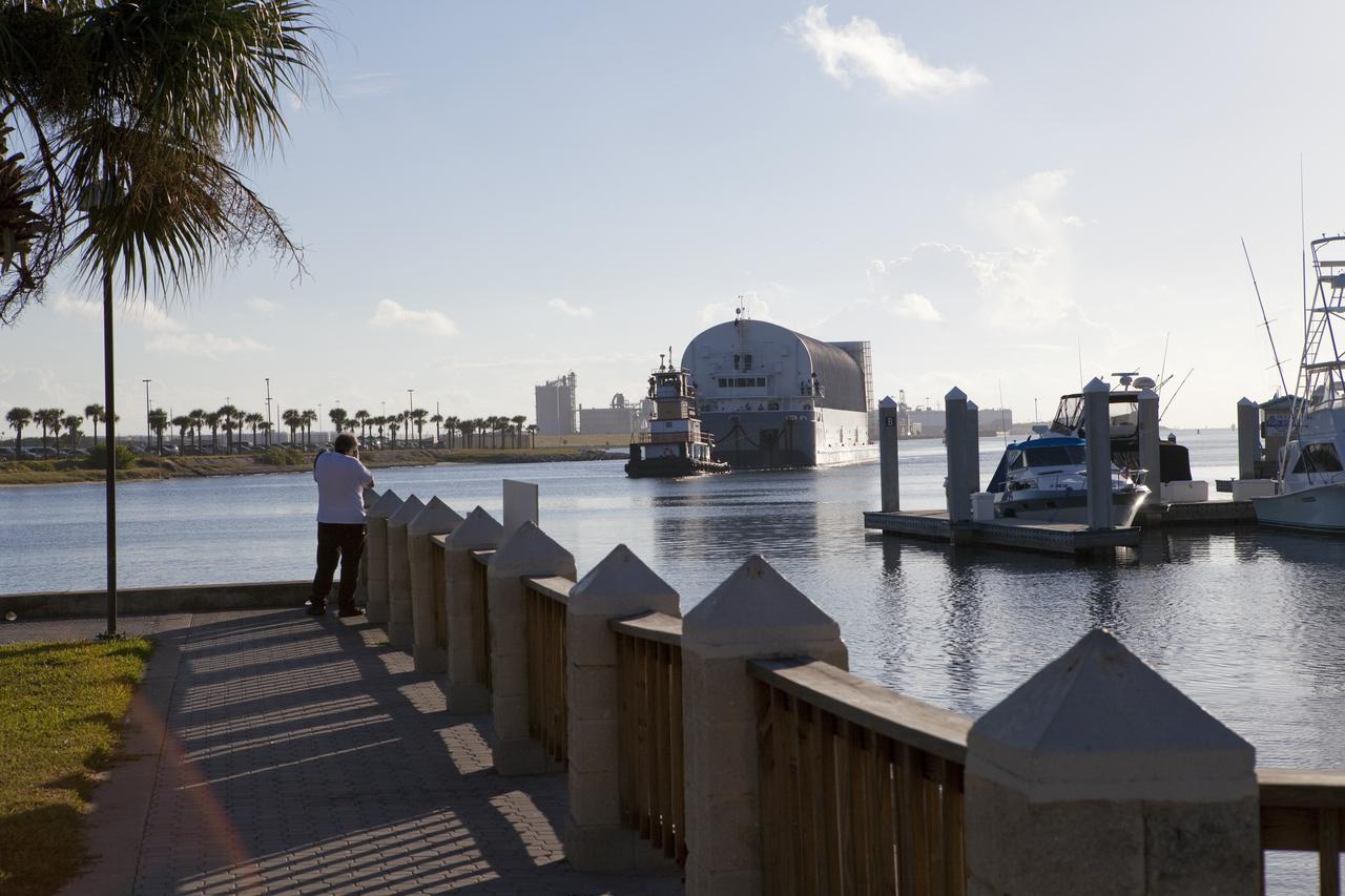 CAPE CANAVERAL, Fla. -- A tug boat pulls the Space Shuttle Program's last external fuel tank, ET-122, toward the Turn Basin at NASA's Kennedy Space Center in Florida. The tank traveled 900 miles by sea from NASA's Michoud Assembly Facility in New Orleans aboard the Pegasus Barge. Next, the tank will be offloaded and moved to Kennedy's Vehicle Assembly Building where it eventually will be attached to space shuttle Endeavour for the STS-134 mission to the International Space Station. STS-134, targeted to launch in Feb. 2011, currently is scheduled to be the last mission in the Space Shuttle Program.        The tank, which is the largest element of the space shuttle stack, was damaged during Hurricane Katrina in August 2005 and restored to flight configuration by Lockheed Martin Space Systems Company employees. Photo credit: NASA/Frankie Martin