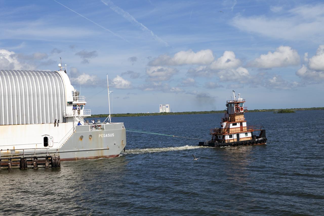 CAPE CANAVERAL, Fla. -- A tug boat pulls the Space Shuttle Program's last external fuel tank, ET-122, to the Turn Basin at NASA's Kennedy Space Center in Florida. The tank traveled 900 miles by sea from NASA's Michoud Assembly Facility in New Orleans aboard the Pegasus Barge. Next, the tank will be offloaded and moved to Kennedy's Vehicle Assembly Building where it eventually will be attached to space shuttle Endeavour for the STS-134 mission to the International Space Station. STS-134, targeted to launch in Feb. 2011, currently is scheduled to be the last mission in the Space Shuttle Program.        The tank, which is the largest element of the space shuttle stack, was damaged during Hurricane Katrina in August 2005 and restored to flight configuration by Lockheed Martin Space Systems Company employees. Photo credit: NASA/Frankie Martin