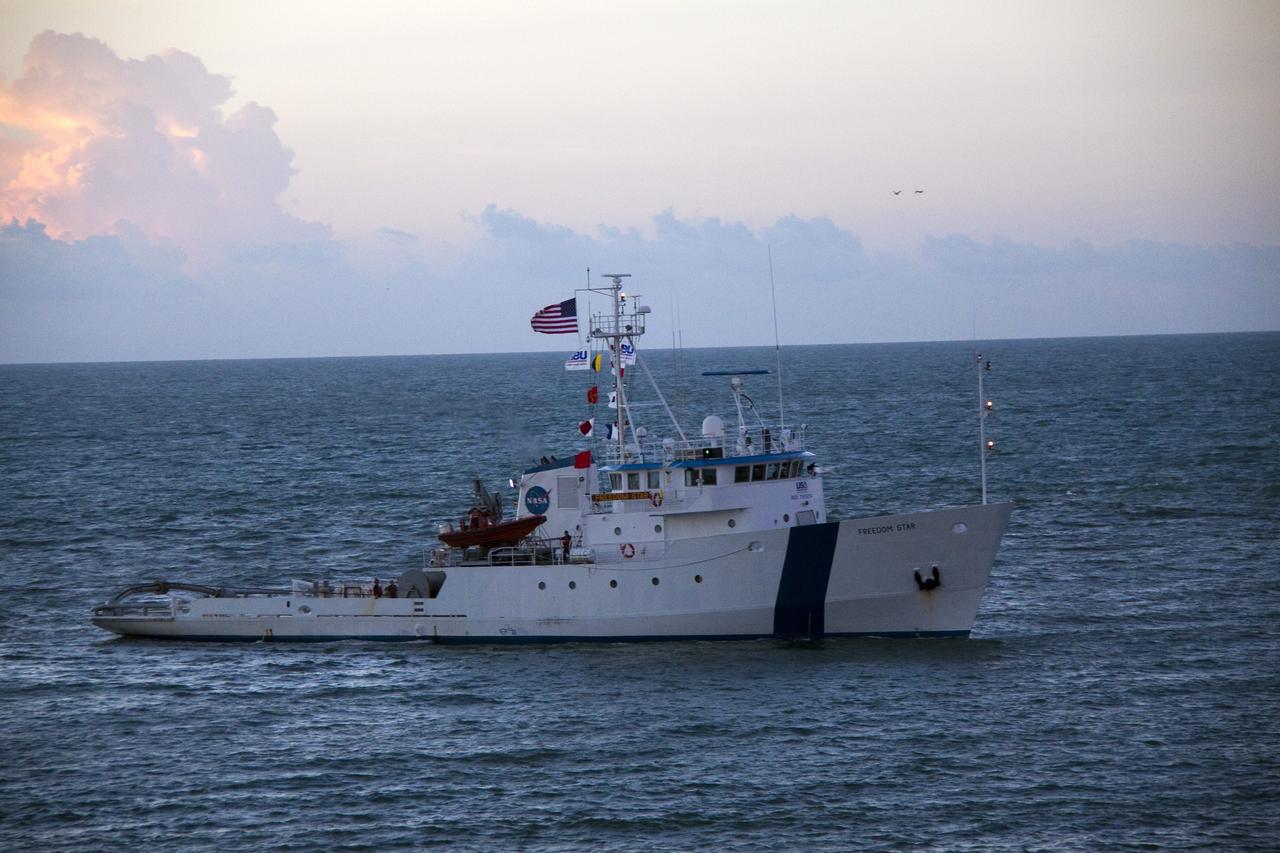 CAPE CANAVERAL, Fla. -- Freedom Star, one of NASA's solid rocket booster retrieval ships, pulls the Space Shuttle Program's last external fuel tank, ET-122, toward NASA's Kennedy Space Center in Florida. The tank traveled 900 miles by sea from NASA's Michoud Assembly Facility in New Orleans aboard the Pegasus Barge. After reaching the Turn Basin at Kennedy, the tank will be offloaded and moved to the Vehicle Assembly Building where it eventually will be attached to space shuttle Endeavour for the STS-134 mission to the International Space Station. STS-134, targeted to launch in Feb. 2011, currently is scheduled to be the last mission in the Space Shuttle Program.        The tank, which is the largest element of the space shuttle stack, was damaged during Hurricane Katrina in August 2005 and restored to flight configuration by Lockheed Martin Space Systems Company employees. Photo credit: NASA/Jack Pfaller