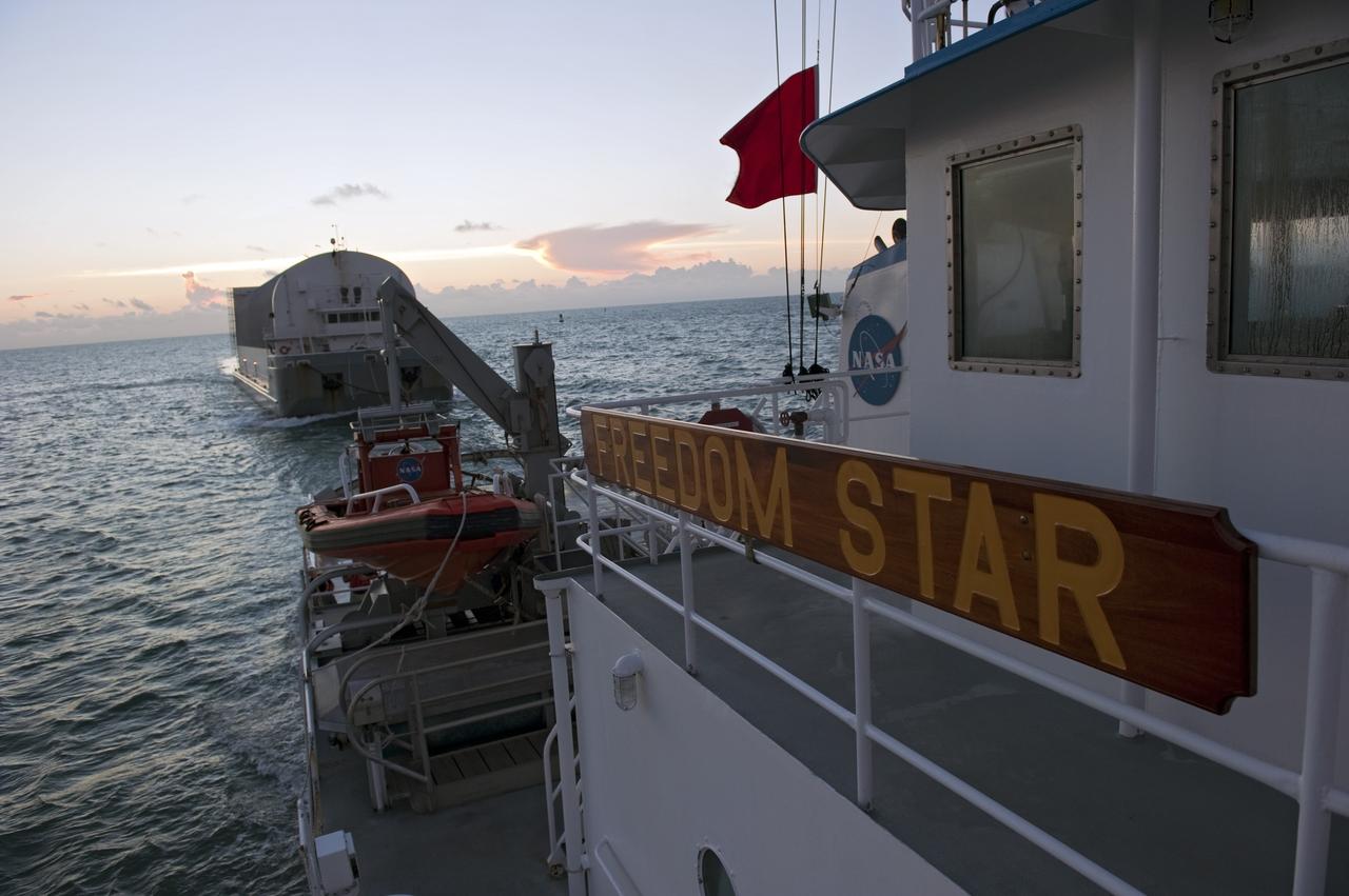 CAPE CANAVERAL, Fla. -- Freedom Star, one of NASA's solid rocket booster retrieval ships, pulls the Space Shuttle Program's last external fuel tank, ET-122, toward NASA's Kennedy Space Center in Florida. The tank traveled 900 miles by sea from NASA's Michoud Assembly Facility in New Orleans aboard the Pegasus Barge. After reaching the Turn Basin at Kennedy, the tank will be offloaded and moved to the Vehicle Assembly Building where it eventually will be attached to space shuttle Endeavour for the STS-134 mission to the International Space Station. STS-134, targeted to launch in Feb. 2011, currently is scheduled to be the last mission in the Space Shuttle Program.           The tank, which is the largest element of the space shuttle stack, was damaged during Hurricane Katrina in August 2005 and restored to flight configuration by Lockheed Martin Space Systems Company employees. Photo credit: NASA/Kim Shiflett