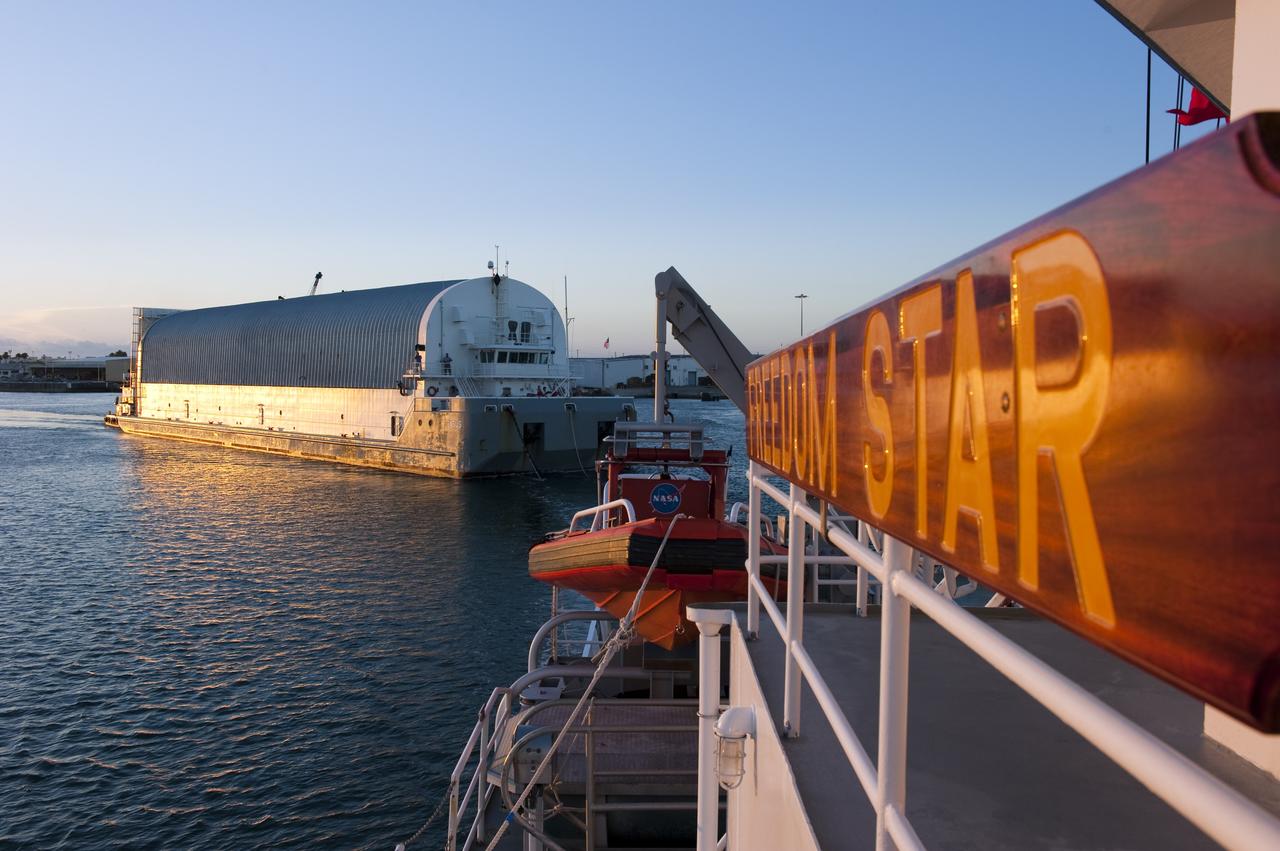 CAPE CANAVERAL, Fla. -- Freedom Star, one of NASA's solid rocket booster retrieval ships, pulls the Space Shuttle Program's last external fuel tank, ET-122, toward NASA's Kennedy Space Center in Florida. The tank traveled 900 miles by sea from NASA's Michoud Assembly Facility in New Orleans aboard the Pegasus Barge. After reaching the Turn Basin at Kennedy, the tank will be offloaded and moved to the Vehicle Assembly Building where it eventually will be attached to space shuttle Endeavour for the STS-134 mission to the International Space Station. STS-134, targeted to launch in Feb. 2011, currently is scheduled to be the last mission in the Space Shuttle Program.            The tank, which is the largest element of the space shuttle stack, was damaged during Hurricane Katrina in August 2005 and restored to flight configuration by Lockheed Martin Space Systems Company employees. Photo credit: NASA/Kim Shiflett