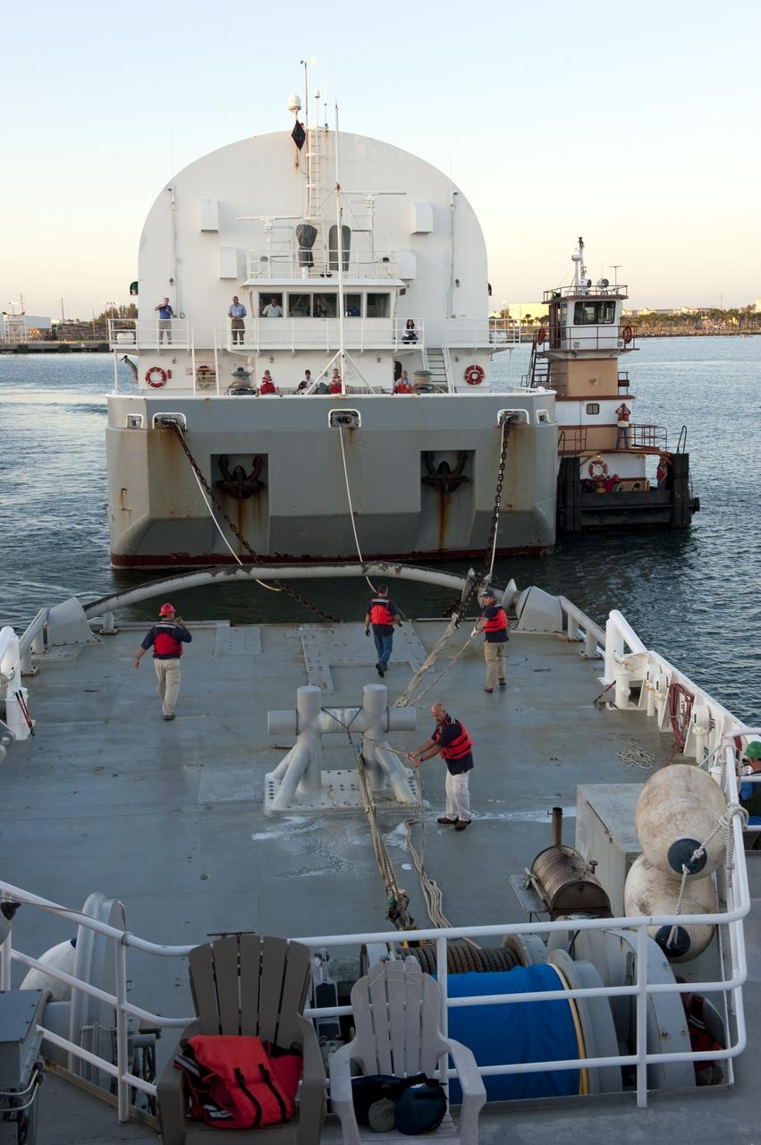 CAPE CANAVERAL, Fla. -- Workers aboard Freedom Star, one of NASA's solid rocket booster retrieval ships, disconnect their ship from the Pegasus Barge, which is carrying the Space Shuttle Program's last external fuel tank, ET-122, toward NASA's Kennedy Space Center in Florida. The tank traveled 900 miles by sea from NASA's Michoud Assembly Facility in New Orleans. After reaching the Turn Basin at Kennedy, the tank will be offloaded and moved to the Vehicle Assembly Building where it eventually will be attached to space shuttle Endeavour for the STS-134 mission to the International Space Station. STS-134, targeted to launch in Feb. 2011, currently is scheduled to be the last mission in the Space Shuttle Program.             The tank, which is the largest element of the space shuttle stack, was damaged during Hurricane Katrina in August 2005 and restored to flight configuration by Lockheed Martin Space Systems Company employees. Photo credit: NASA/Kim Shiflett