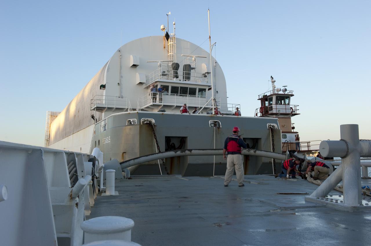 CAPE CANAVERAL, Fla. -- Workers aboard Freedom Star, one of NASA's solid rocket booster retrieval ships, disconnect their ship from the Pegasus Barge, which is carrying the Space Shuttle Program's last external fuel tank, ET-122, toward NASA's Kennedy Space Center in Florida. The tank traveled 900 miles by sea from NASA's Michoud Assembly Facility in New Orleans. After reaching the Turn Basin at Kennedy, the tank will be offloaded and moved to the Vehicle Assembly Building where it eventually will be attached to space shuttle Endeavour for the STS-134 mission to the International Space Station. STS-134, targeted to launch in Feb. 2011, currently is scheduled to be the last mission in the Space Shuttle Program.         The tank, which is the largest element of the space shuttle stack, was damaged during Hurricane Katrina in August 2005 and restored to flight configuration by Lockheed Martin Space Systems Company employees. Photo credit: NASA/Kim Shiflett