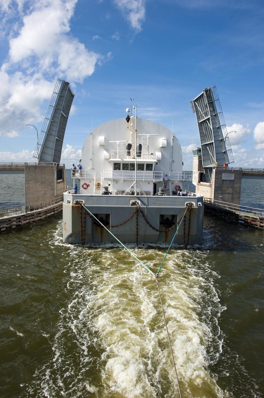 CAPE CANAVERAL, Fla. -- NASA's Pegasus barge is pulled through the bridge at the NASA Causeway. The barge is carrying the Space Shuttle Program's last external fuel tank, ET-122, toward NASA's Kennedy Space Center in Florida. The tank traveled 900 miles by sea from NASA's Michoud Assembly Facility in New Orleans. After reaching the Turn Basin at Kennedy, the tank will be offloaded and moved to the Vehicle Assembly Building where it eventually will be attached to space shuttle Endeavour for the STS-134 mission to the International Space Station. STS-134, targeted to launch in Feb. 2011, currently is scheduled to be the last mission in the Space Shuttle Program.         The tank, which is the largest element of the space shuttle stack, was damaged during Hurricane Katrina in August 2005 and restored to flight configuration by Lockheed Martin Space Systems Company employees. Photo credit: NASA/Kim Shiflett