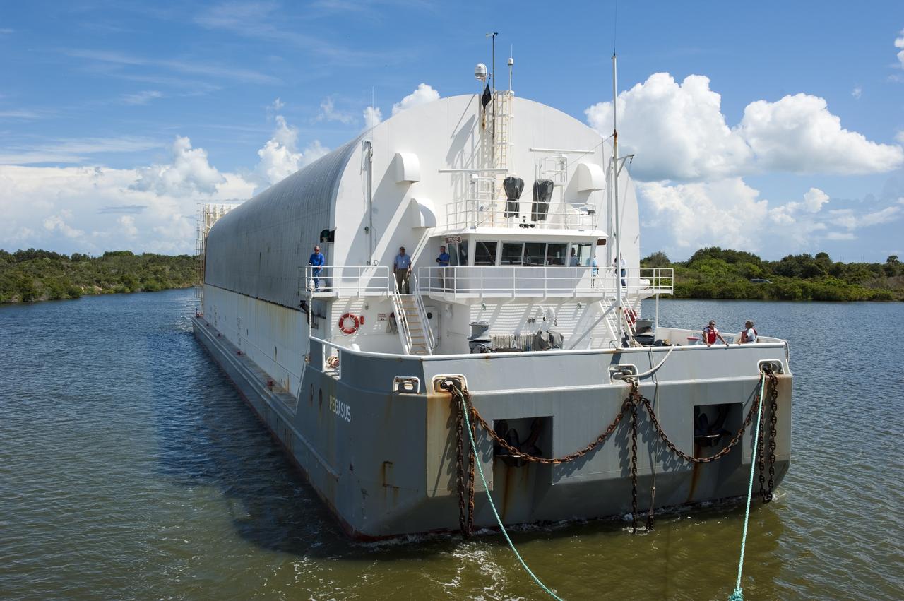 CAPE CANAVERAL, Fla. -- NASA's Pegasus barge is pulled toward NASA's Kennedy Space Center in Florida by a tug boat. The barge is carrying the Space Shuttle Program's last external fuel tank, ET-122 and traveled 900 miles by sea from NASA's Michoud Assembly Facility in New Orleans. After reaching the Turn Basin at Kennedy, the tank will be offloaded and moved to the Vehicle Assembly Building where it eventually will be attached to space shuttle Endeavour for the STS-134 mission to the International Space Station. STS-134, targeted to launch in Feb. 2011, currently is scheduled to be the last mission in the Space Shuttle Program. The tank, which is the largest element of the space shuttle stack, was damaged during Hurricane Katrina in August 2005 and restored to flight configuration by Lockheed Martin Space Systems Company employees. Photo credit: NASA/Kim Shiflett