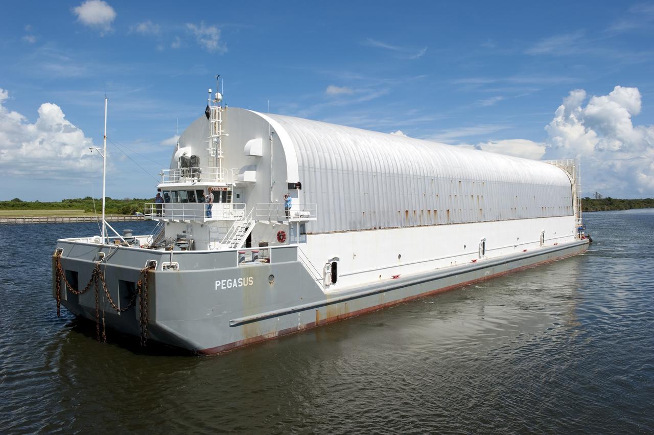 CAPE CANAVERAL, Fla. -- NASA's Pegasus barge, carrying the Space Shuttle Program's last external fuel tank, ET-122, arrives at the Turn Basin of NASA's Kennedy Space Center in Florida. The tank traveled 900 miles by sea from NASA's Michoud Assembly Facility in New Orleans. Next, the tank will be offloaded and moved to the Vehicle Assembly Building where it eventually will be attached to space shuttle Endeavour for the STS-134 mission to the International Space Station. STS-134, targeted to launch in Feb. 2011, currently is scheduled to be the last mission in the Space Shuttle Program.         The tank, which is the largest element of the space shuttle stack, was damaged during Hurricane Katrina in August 2005 and restored to flight configuration by Lockheed Martin Space Systems Company employees. Photo credit: NASA/Kim Shiflett