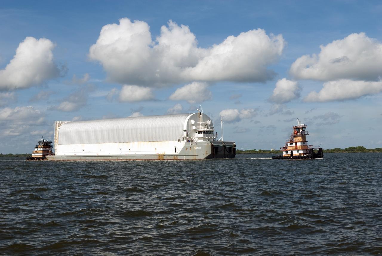 CAPE CANAVERAL, Fla. -- One tugboat pulls while another pushes the Pegasus Barge carrying the Space Shuttle Program's last external fuel tank, ET-122, toward NASA's Kennedy Space Center in Florida. The tank traveled 900 miles by sea from NASA's Michoud Assembly Facility in New Orleans. After reaching the Turn Basin at Kennedy, the tank will be offloaded and moved to the Vehicle Assembly Building where it eventually will be attached to space shuttle Endeavour for the STS-134 mission to the International Space Station. STS-134, targeted to launch in Feb. 2011, currently is scheduled to be the last mission in the Space Shuttle Program.           The tank, which is the largest element of the space shuttle stack, was damaged during Hurricane Katrina in August 2005 and restored to flight configuration by Lockheed Martin Space Systems Company employees. Photo credit: NASA/Jim Grossmann
