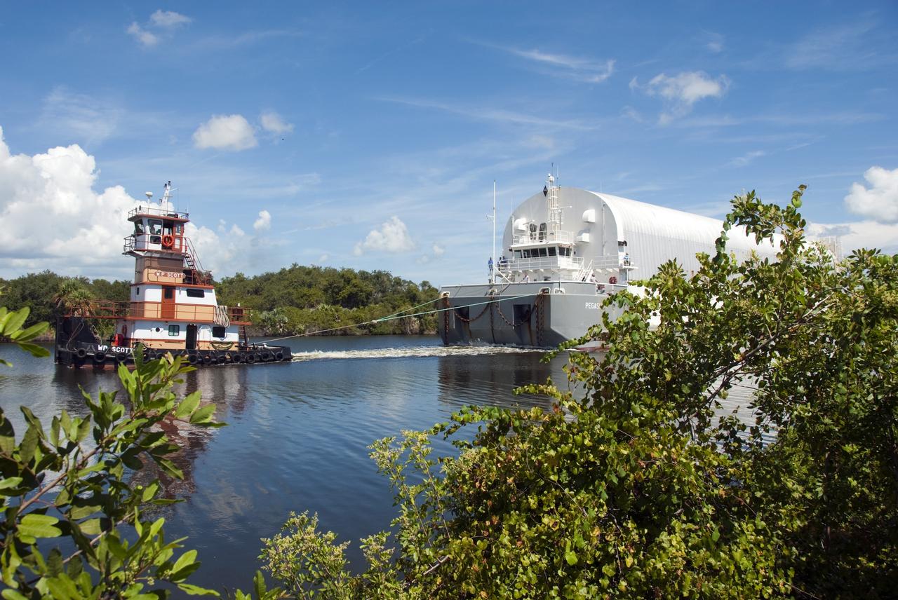 CAPE CANAVERAL, Fla. -- A tugboat pulls the Pegasus Barge carrying the Space Shuttle Program's last external fuel tank, ET-122, toward NASA's Kennedy Space Center in Florida. The tank traveled 900 miles by sea from NASA's Michoud Assembly Facility in New Orleans. After reaching the Turn Basin at Kennedy, the tank will be offloaded and moved to the Vehicle Assembly Building where it eventually will be attached to space shuttle Endeavour for the STS-134 mission to the International Space Station. STS-134, targeted to launch in Feb. 2011, currently is scheduled to be the last mission in the Space Shuttle Program.           The tank, which is the largest element of the space shuttle stack, was damaged during Hurricane Katrina in August 2005 and restored to flight configuration by Lockheed Martin Space Systems Company employees. Photo credit: NASA/Jim Grossmann