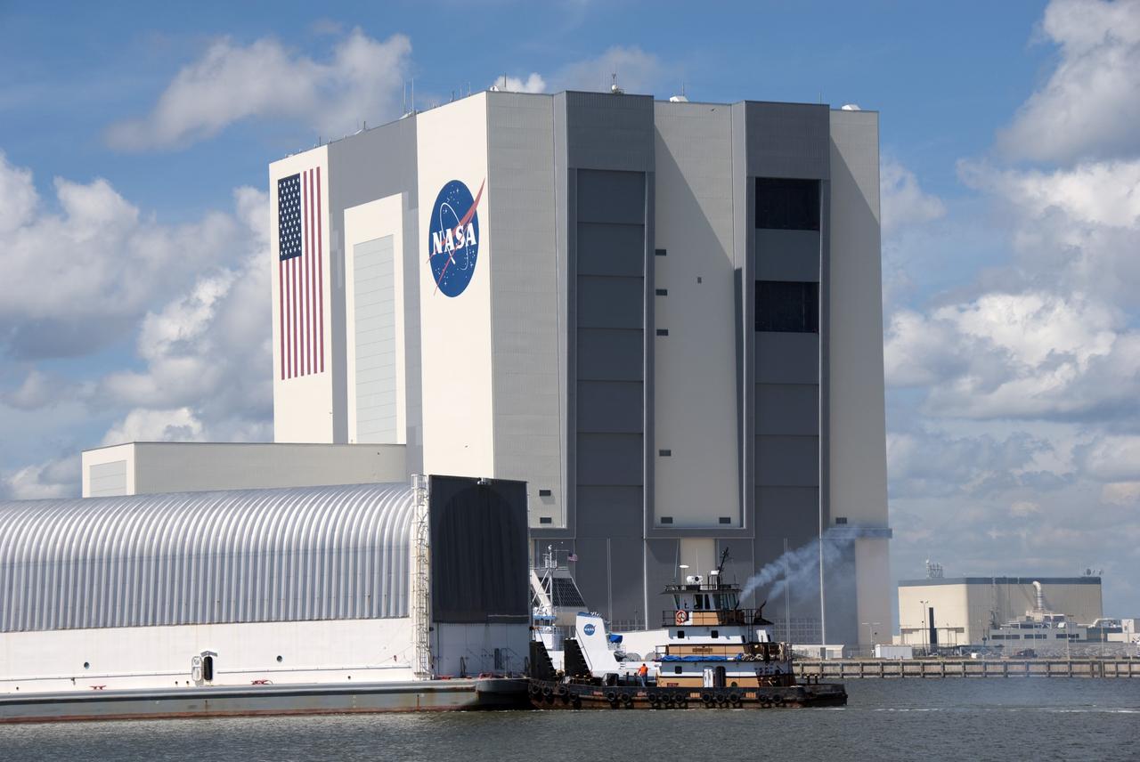 CAPE CANAVERAL, Fla. -- A tugboat pushes the Pegasus Barge carrying the Space Shuttle Program's last external fuel tank, ET-122, toward NASA's Kennedy Space Center in Florida. The tank traveled 900 miles by sea from NASA's Michoud Assembly Facility in New Orleans. After reaching the Turn Basin at Kennedy, the tank will be offloaded and moved to the Vehicle Assembly Building where it eventually will be attached to space shuttle Endeavour for the STS-134 mission to the International Space Station. STS-134, targeted to launch in Feb. 2011, currently is scheduled to be the last mission in the Space Shuttle Program.            The tank, which is the largest element of the space shuttle stack, was damaged during Hurricane Katrina in August 2005 and restored to flight configuration by Lockheed Martin Space Systems Company employees. Photo credit: NASA/Jim Grossmann