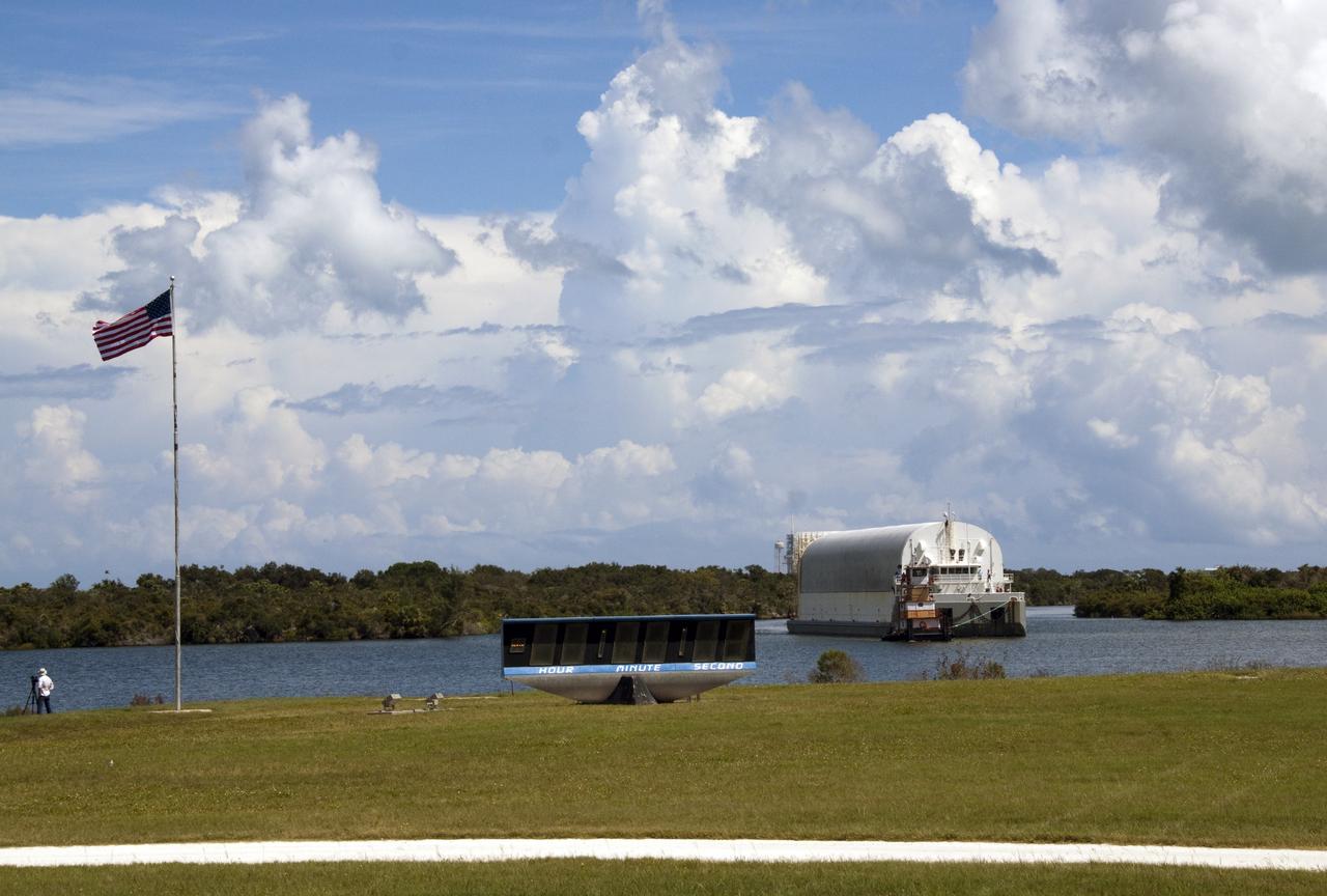 CAPE CANAVERAL, Fla. -- A tugboat pulls the Pegasus Barge carrying the Space Shuttle Program's last external fuel tank, ET-122, toward the Turn Basin at NASA's Kennedy Space Center in Florida. The tank traveled 900 miles by sea from NASA's Michoud Assembly Facility in New Orleans. Next, the tank will be offloaded and moved to the Vehicle Assembly Building where it eventually will be attached to space shuttle Endeavour for the STS-134 mission to the International Space Station. STS-134, targeted to launch in Feb. 2011, currently is scheduled to be the last mission in the Space Shuttle Program.         The tank, which is the largest element of the space shuttle stack, was damaged during Hurricane Katrina in August 2005 and restored to flight configuration by Lockheed Martin Space Systems Company employees. Photo credit: NASA/Jack Pfaller