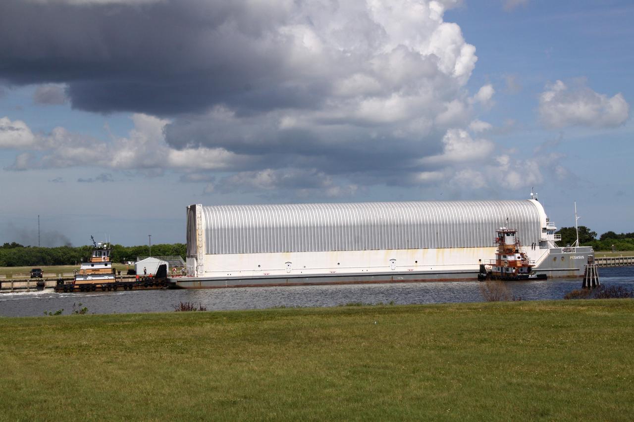 CAPE CANAVERAL, Fla. -- The Pegasus Barge carrying the Space Shuttle Program's last external fuel tank, ET-122, arrives at the Turn Basin at NASA's Kennedy Space Center in Florida. The tank traveled 900 miles by sea from NASA's Michoud Assembly Facility in New Orleans. Next, the tank will be offloaded and moved to the Vehicle Assembly Building where it eventually will be attached to space shuttle Endeavour for the STS-134 mission to the International Space Station. STS-134, targeted to launch in Feb. 2011, currently is scheduled to be the last mission in the Space Shuttle Program.          The tank, which is the largest element of the space shuttle stack, was damaged during Hurricane Katrina in August 2005 and restored to flight configuration by Lockheed Martin Space Systems Company employees. Photo credit: NASA/Jack Pfaller