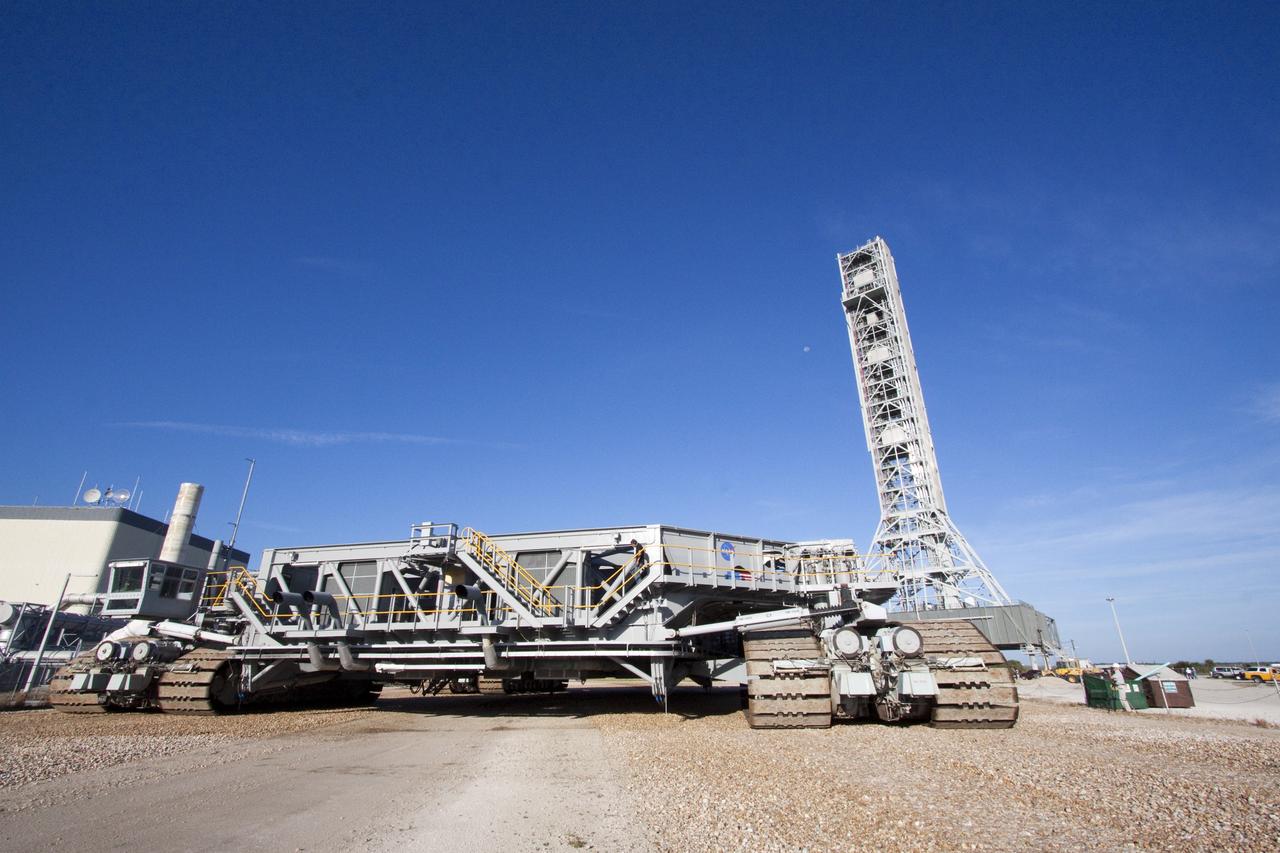 CAPE CANAVERAL, Fla. -- At NASA's Kennedy Space Center in Florida, a crawler-transporter moves toward NASA's new mobile launcher (ML) support structure. The crawler will transport the ML from a construction site, north of the Vehicle Assembly Building, to the Mobile Launcher east park site. Once there, the ML can be outfitted with ground support equipment, such as umbilicals and access arms, for future rocket launches. It took about two years to construct the 355-foot-tall structure, which will support NASA's future human spaceflight program. The base of the launcher is lighter than space shuttle mobile launcher platforms so the crawler-transporter can pick up the heavier load of the tower and a taller rocket. Photo credit: NASA/Jack Pfaller