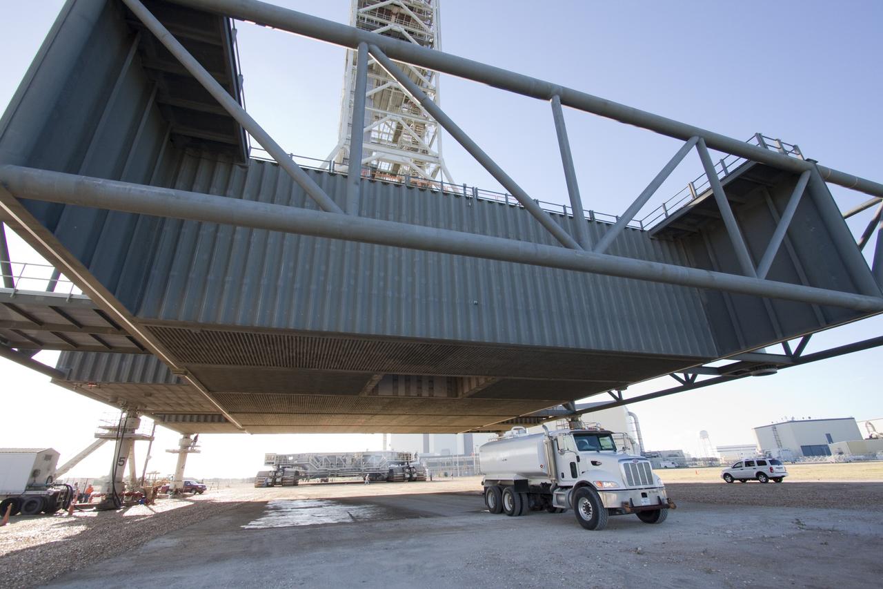 CAPE CANAVERAL, Fla. -- At NASA's Kennedy Space Center in Florida, a crawler-transporter approaches NASA's new mobile launcher (ML) support structure. The crawler will transport the ML from a construction site, north of the Vehicle Assembly Building, to the Mobile Launcher east park site. Once there, the ML can be outfitted with ground support equipment, such as umbilicals and access arms, for future rocket launches. It took about two years to construct the 355-foot-tall structure, which will support NASA's future human spaceflight program. The base of the launcher is lighter than space shuttle mobile launcher platforms so the crawler-transporter can pick up the heavier load of the tower and a taller rocket. Photo credit: NASA/Jack Pfaller