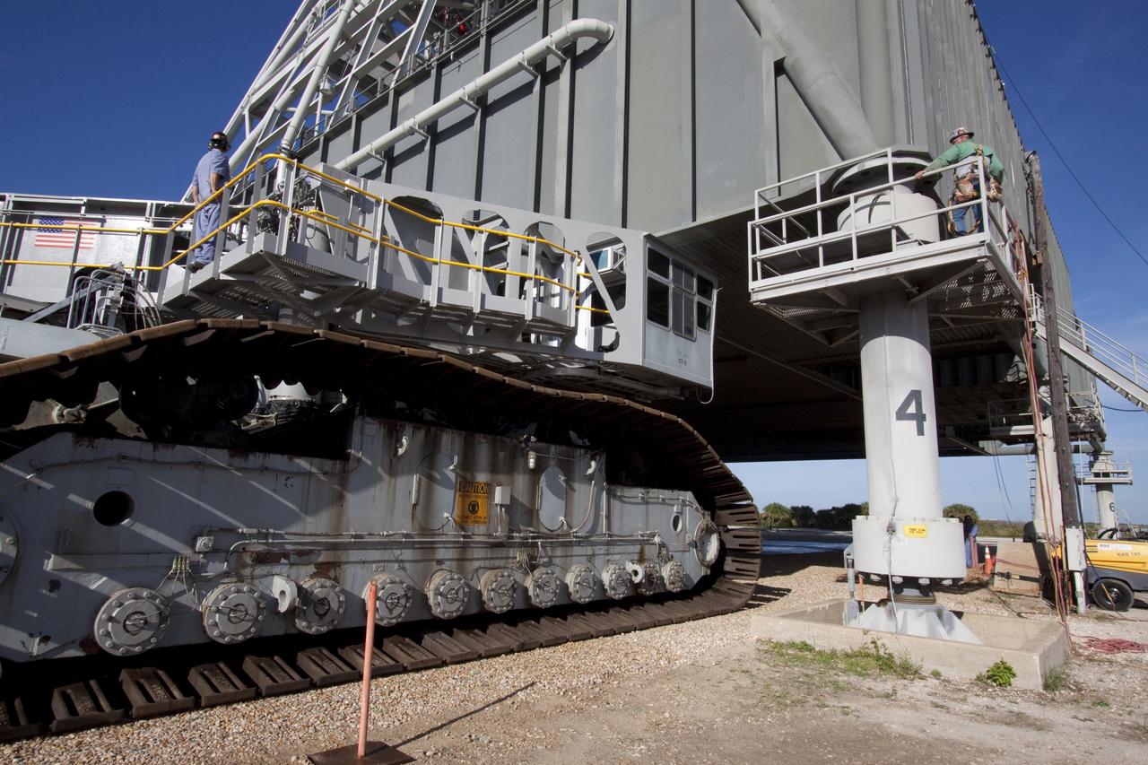 CAPE CANAVERAL, Fla. -- At NASA's Kennedy Space Center in Florida, a crawler-transporter moves under NASA's new mobile launcher (ML) support structure. The crawler will transport the ML from a construction site, north of the Vehicle Assembly Building, to the Mobile Launcher east park site. Once there, the ML can be outfitted with ground support equipment, such as umbilicals and access arms, for future rocket launches. It took about two years to construct the 355-foot-tall structure, which will support NASA's future human spaceflight program. The base of the launcher is lighter than space shuttle mobile launcher platforms so the crawler-transporter can pick up the heavier load of the tower and a taller rocket. Photo credit: NASA/Jack Pfaller