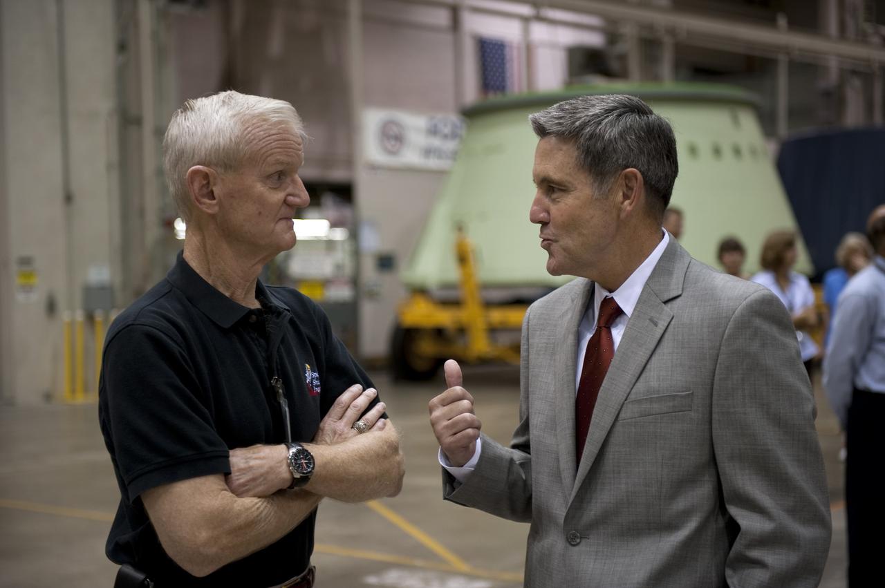 CAPE CANAVERAL, Fla. -- At NASA's Kennedy Space Center in Florida, John Casper, Assistant Space Shuttle Program manager and Kennedy Center Director Bob Cabana talk with each other during a ceremony being held to commemorate the move from Kennedy's Assembly Refurbishment Facility (ARF) to the Vehicle Assembly Building (VAB) of the Space Shuttle Program's final solid rocket booster structural assembly -- the right-hand forward. The move was postponed because of inclement weather. Photo credit: NASA/Kim Shiflett