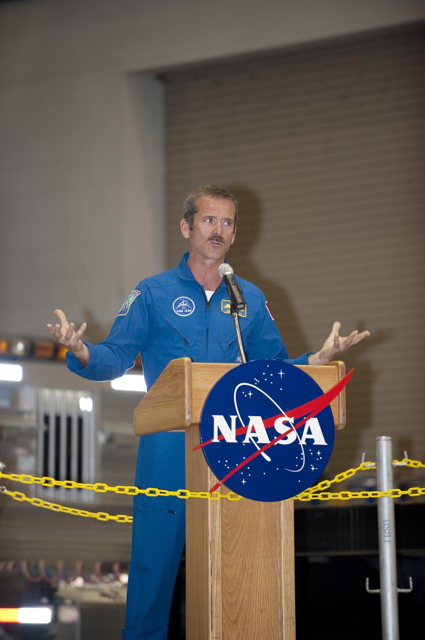 CAPE CANAVERAL, Fla. -- At NASA's Kennedy Space Center in Florida, Canadian Space Agency astronaut Chris Hadfield address the attendees at a ceremony being held to commemorate the move from Kennedy's Assembly Refurbishment Facility (ARF) to the Vehicle Assembly Building (VAB) of the Space Shuttle Program's final solid rocket booster structural assembly -- the right-hand forward. The move was postponed because of inclement weather. Photo credit: NASA/Kim Shiflett