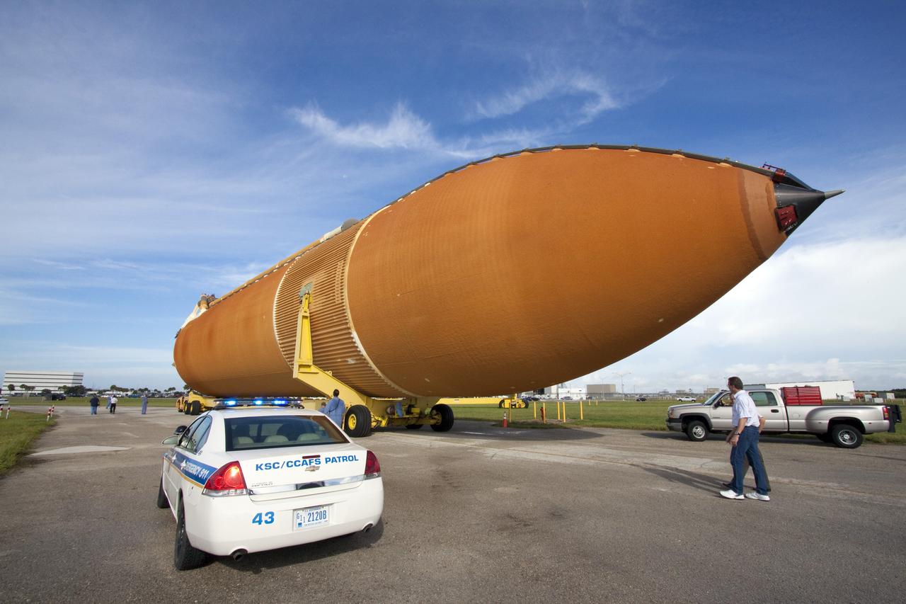 CAPE CANAVERAL, Fla. -- The Space Shuttle Program's last external fuel tank, ET-122, moves from the Turn Basin to the Vehicle Assembly Building at NASA's Kennedy Space Center in Florida. The tank traveled 900 miles by sea from NASA's Michoud Assembly Facility in New Orleans aboard the Pegasus Barge. Once inside the Vehicle Assembly Building, it eventually will be attached to space shuttle Endeavour for the STS-134 mission to the International Space Station. STS-134, targeted to launch in Feb. 2011, currently is scheduled to be the last mission in the shuttle program.          The tank, which is the largest element of the space shuttle stack, was damaged during Hurricane Katrina in August 2005 and restored to flight configuration by Lockheed Martin Space Systems Company employees. Photo credit: NASA/Jack Pfaller