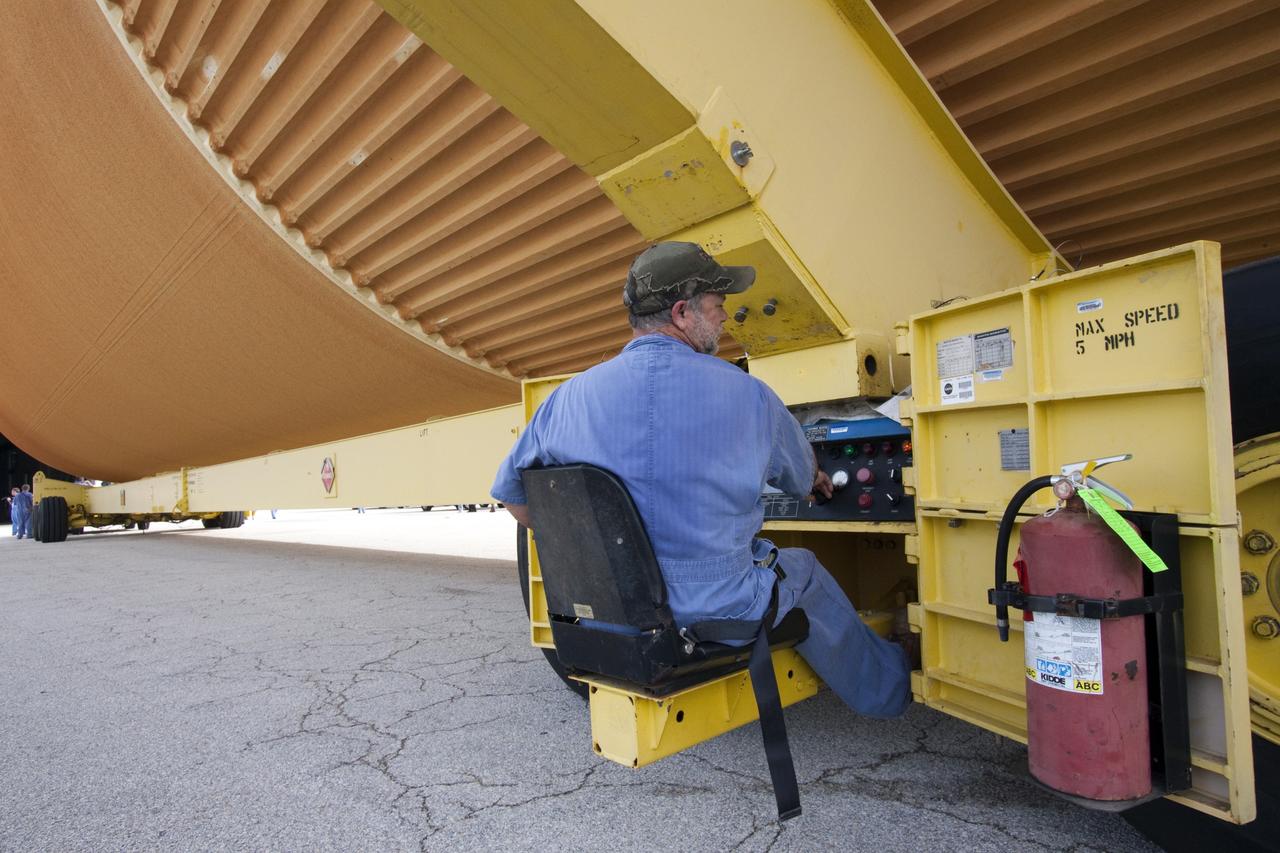 CAPE CANAVERAL, Fla. -- A United Space Alliance technician monitors the Space Shuttle Program's last external fuel tank, ET-122, as it moves from the Turn Basin to the Vehicle Assembly Building at NASA's Kennedy Space Center in Florida. The tank traveled 900 miles by sea from NASA's Michoud Assembly Facility in New Orleans aboard the Pegasus Barge. Once inside the Vehicle Assembly Building, it eventually will be attached to space shuttle Endeavour for the STS-134 mission to the International Space Station. STS-134, targeted to launch in Feb. 2011, currently is scheduled to be the last mission in the shuttle program.          The tank, which is the largest element of the space shuttle stack, was damaged during Hurricane Katrina in August 2005 and restored to flight configuration by Lockheed Martin Space Systems Company employees. Photo credit: NASA/Jack Pfaller