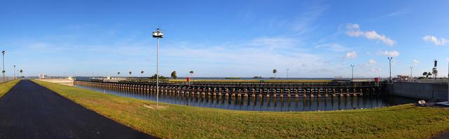 CAPE CANAVERAL, Fla. -- This panoramic image shows the Pegasus Barge carrying the Space Shuttle Program's last external fuel tank, ET-122, through the Port Canaveral locks on its way to the Turn Basin at NASA's Kennedy Space Center in Florida. Once docked, the tank will be offloaded from the barge and transported to the Vehicle Assembly Building (VAB).          The tank traveled 900 miles by sea, carried in the barge, from NASA's Michoud Assembly Facility in New Orleans. Once inside the VAB, it eventually will be attached to space shuttle Endeavour for the STS-134 mission to the International Space Station targeted to launch Feb. 2011. STS-134 currently is scheduled to be the last mission in the shuttle program. The tank, which is the largest element of the space shuttle stack, was damaged during Hurricane Katrina in August 2005 and restored to flight configuration by Lockheed Martin Space Systems Company employees. Photo credit: NASA/Frankie Martin
