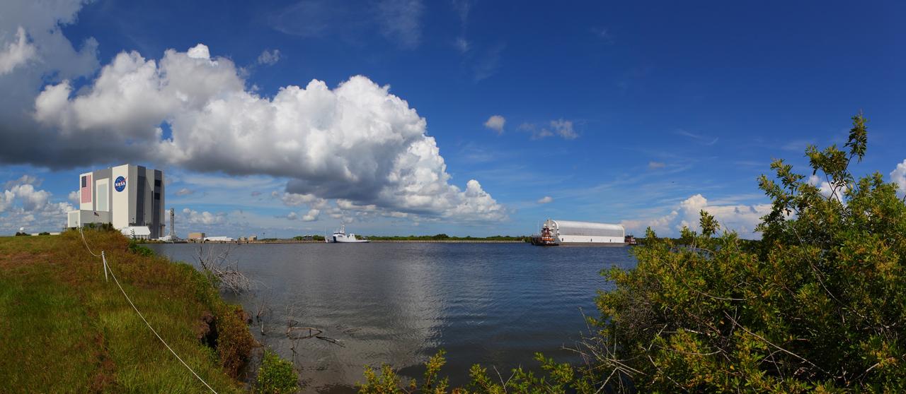 CAPE CANAVERAL, Fla. -- This panoramic image shows tug boats maneuvering the Pegasus Barge carrying the Space Shuttle Program's last external fuel tank, ET-122, through the Turn Basin at NASA's Kennedy Space Center in Florida. Once docked, the tank will be offloaded from the barge and transported to the Vehicle Assembly Building (VAB). NASA's Liberty Star solid rocket booster retrieval ship is seen (left) docked at the Turn Basin. The tank traveled 900 miles by sea, carried in the barge, from NASA's Michoud Assembly Facility in New Orleans. Once inside the VAB, it eventually will be attached to space shuttle Endeavour for the STS-134 mission to the International Space Station targeted to launch Feb. 2011. STS-134 currently is scheduled to be the last mission in the shuttle program. The tank, which is the largest element of the space shuttle stack, was damaged during Hurricane Katrina in August 2005 and restored to flight configuration by Lockheed Martin Space Systems Company employees. Photo credit: NASA/Frankie Martin