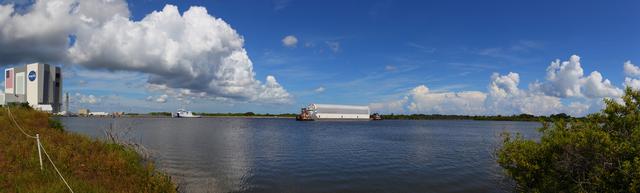 CAPE CANAVERAL, Fla. -- This panoramic image shows tug boats maneuvering the Pegasus Barge carrying the Space Shuttle Program's last external fuel tank, ET-122, through the Turn Basin at NASA's Kennedy Space Center in Florida. Once docked, the tank will be offloaded from the barge and transported to the Vehicle Assembly Building (VAB). NASA's Liberty Star solid rocket booster retrieval ship is also seen (left) docked at the Turn Basin. The tank traveled 900 miles by sea, carried in the barge, from NASA's Michoud Assembly Facility in New Orleans. Once inside the VAB, it eventually will be attached to space shuttle Endeavour for the STS-134 mission to the International Space Station targeted to launch Feb. 2011. STS-134 currently is scheduled to be the last mission in the shuttle program. The tank, which is the largest element of the space shuttle stack, was damaged during Hurricane Katrina in August 2005 and restored to flight configuration by Lockheed Martin Space Systems Company employees. Photo credit: NASA/Frankie Martin