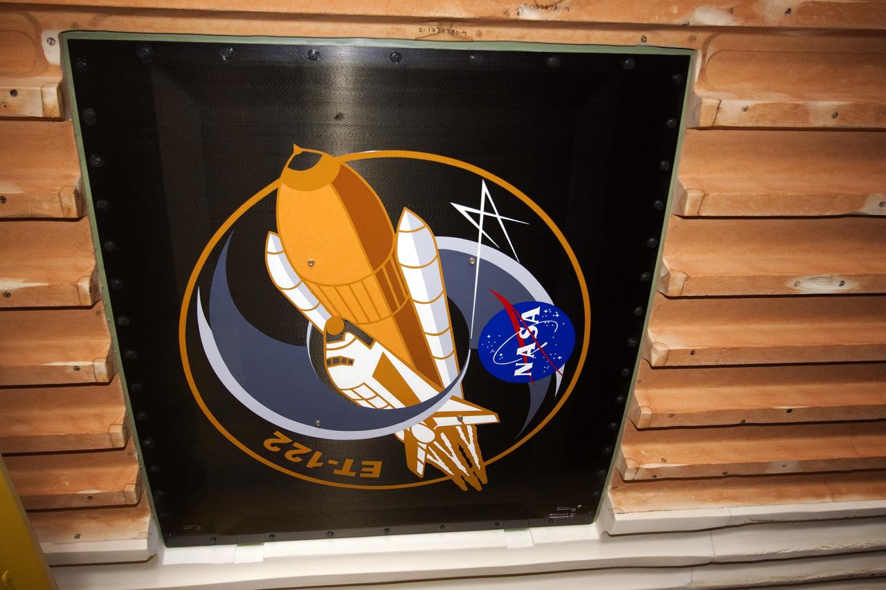 CAPE CANAVERAL, Fla. -- To commemorate the history of the Space Shuttle Program's last external fuel tank, its intertank door is emblazoned with an ET-122 insignia. The tank is in the Vehicle Assembly Building at NASA's Kennedy Space Center in Florida after traveling 900 miles by sea from NASA's Michoud Assembly Facility in New Orleans aboard the Pegasus Barge. It eventually will be attached to space shuttle Endeavour for the STS-134 mission to the International Space Station. STS-134, targeted to launch in Feb. 2011, currently is scheduled to be the last mission in the shuttle program.           The tank, which is the largest element of the space shuttle stack, was completed in 2002, modified during Return to Flight operations in 2003 and 2004, damaged during Hurricane Katrina in 2005, and then restored to flight configuration by Lockheed Martin Space Systems Company employees in 2008 at NASA's Marshall Space Flight Center in Alabama. Photo credit: NASA/Jack Pfaller