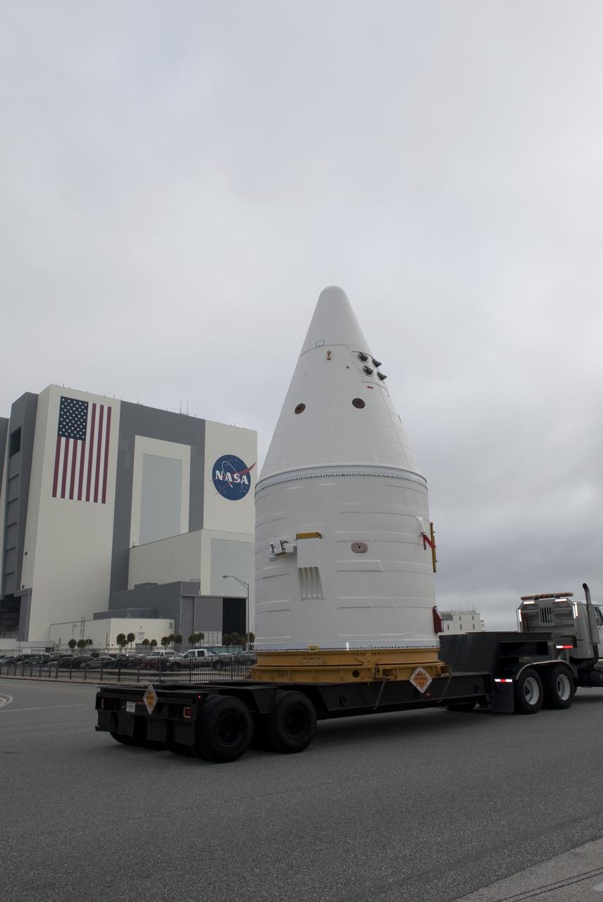 CAPE CANAVERAL, Fla. -- At NASA's Kennedy Space Center in Florida, the Space Shuttle Program's final solid rocket booster assembly -- the right-hand forward -- is being transported from Kennedy's Assembly Refurbishment Facility to the Vehicle Assembly Building (VAB).          The right and left forward assemblies, which are refurbished and processed at Kennedy, are comprised of three components -- nose cap, frustum and forward skirt. Inside the VAB, the boosters will be stacked, then joined to an external fuel tank and space shuttle Atlantis for what currently is planned as the "launch on need," or potential rescue mission, for Endeavour's STS-134 mission to the International Space Station targeted to launch in February, 2011. Photo credit: NASA/Jim Grossmann