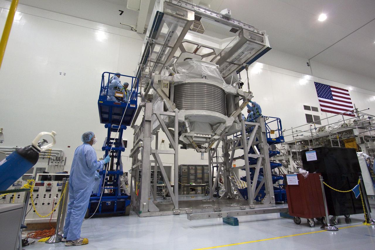 CAPE CANAVERAL, Fla. -- In the Space Station Processing Facility at NASA's Kennedy Space Center in Florida, technicians begin the process of attaching an overhead hoist to the Alpha Magnetic Spectrometer (AMS) for its move to a rotation stand to begin processing for flight. AMS, a state-of-the-art particle physics detector, is designed to operate as an external experiment on the International Space Station. It will use the unique environment of space to study the universe and its origin by searching for dark matter. AMS will fly to the station aboard space shuttle Endeavour's STS-134 mission targeted to launch February, 2011. For more information visit: http://www.nasa.gov/mission_pages/shuttle/shuttlemissions/sts134/index.html. Photo credit: NASA/Jack Pfaller