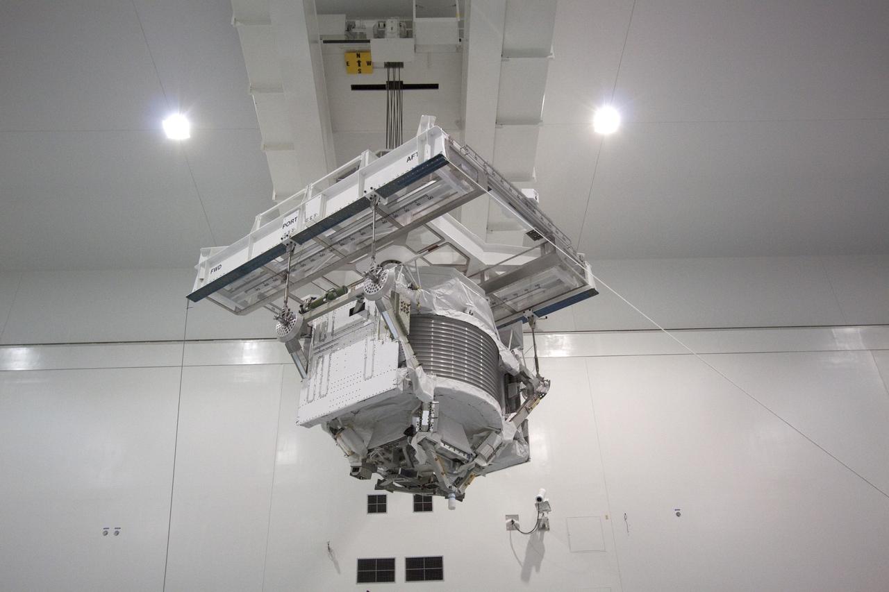 CAPE CANAVERAL, Fla. -- In the Space Station Processing Facility at NASA's Kennedy Space Center in Florida, an overhead hoist transfers the Alpha Magnetic Spectrometer (AMS) to a rotation stand to begin processing for flight.      AMS, a state-of-the-art particle physics detector, is designed to operate as an external experiment on the International Space Station. It will use the unique environment of space to study the universe and its origin by searching for dark matter. AMS will fly to the station aboard space shuttle Endeavour's STS-134 mission targeted to launch February, 2011. For more information visit: http://www.nasa.gov/mission_pages/shuttle/shuttlemissions/sts134/index.htmlPhoto credit: NASA/Jack Pfaller