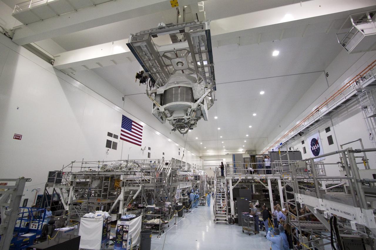CAPE CANAVERAL, Fla. -- High overhead in the Space Station Processing Facility at NASA's Kennedy Space Center in Florida, a hoist transfers the Alpha Magnetic Spectrometer (AMS) to a rotation stand to begin processing for flight.      AMS, a state-of-the-art particle physics detector, is designed to operate as an external experiment on the International Space Station. It will use the unique environment of space to study the universe and its origin by searching for dark matter. AMS will fly to the station aboard space shuttle Endeavour's STS-134 mission targeted to launch February, 2011. For more information visit: http://www.nasa.gov/mission_pages/shuttle/shuttlemissions/sts134/index.html. Photo credit: NASA/Jack Pfaller