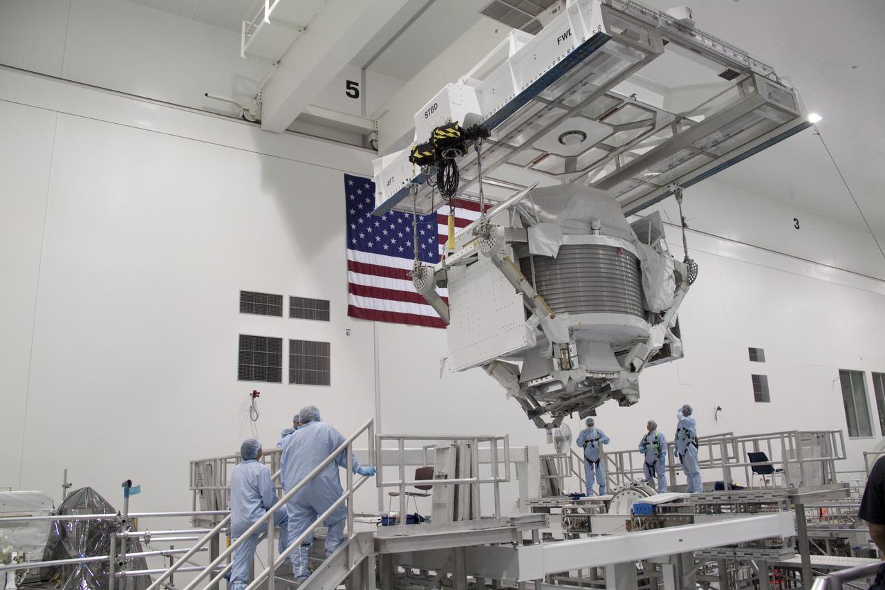 CAPE CANAVERAL, Fla. -- In the Space Station Processing Facility at NASA's Kennedy Space Center in Florida, an overhead hoist lowers the Alpha Magnetic Spectrometer (AMS) onto a rotation stand where it will be tested and processed for launch.    AMS, a state-of-the-art particle physics detector, is designed to operate as an external experiment on the International Space Station. It will use the unique environment of space to study the universe and its origin by searching for dark matter. AMS will fly to the station aboard space shuttle Endeavour's STS-134 mission targeted to launch February, 2011. For more information visit: http://www.nasa.gov/mission_pages/shuttle/shuttlemissions/sts134/index.html. Photo credit: NASA/Jack Pfaller
