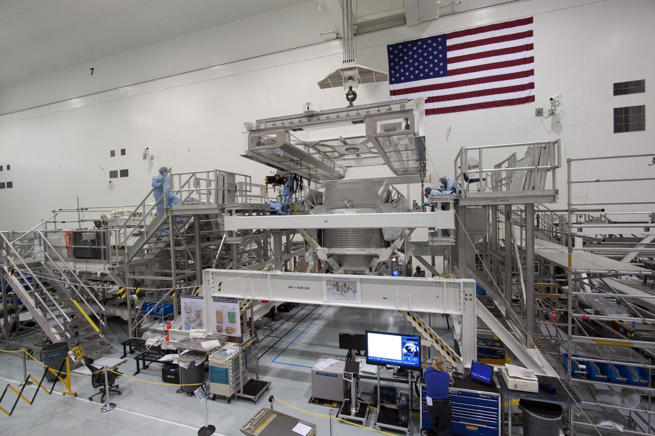 CAPE CANAVERAL, Fla. -- In the Space Station Processing Facility at NASA's Kennedy Space Center in Florida, technicians secure the Alpha Magnetic Spectrometer (AMS) onto a rotation stand where it will be tested and processed for launch.    AMS, a state-of-the-art particle physics detector, is designed to operate as an external experiment on the International Space Station. It will use the unique environment of space to study the universe and its origin by searching for dark matter. AMS will fly to the station aboard space shuttle Endeavour's STS-134 mission targeted to launch February, 2011. For more information visit: http://www.nasa.gov/mission_pages/shuttle/shuttlemissions/sts134/index.html. Photo credit: NASA/Jack Pfaller