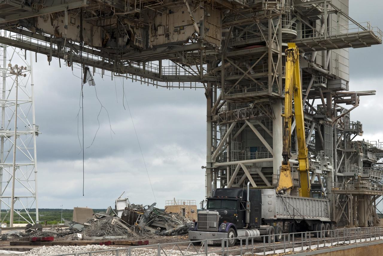 CAPE CANAVERAL, Fla. -- At NASA's Kennedy Space Center in Florida, the rotating service structure (RSS) on Launch Pad 39B is being dismantled. Sand, reinforcing steel and large wooden mats were put down under the RSS to protect the structure's concrete from falling debris during deconstruction.           Starting in 2009, the structure at the pad was no longer needed for NASA's Space Shuttle Program, so it is being restructured for future use. The new design will feature a "clean pad" for rockets to come with their own launcher, making it more versatile for a number of vehicles. The new lightning protection system, consisting of three lightning towers and a wire catenary system will remain. Photo credit: NASA/Jim Grossmann