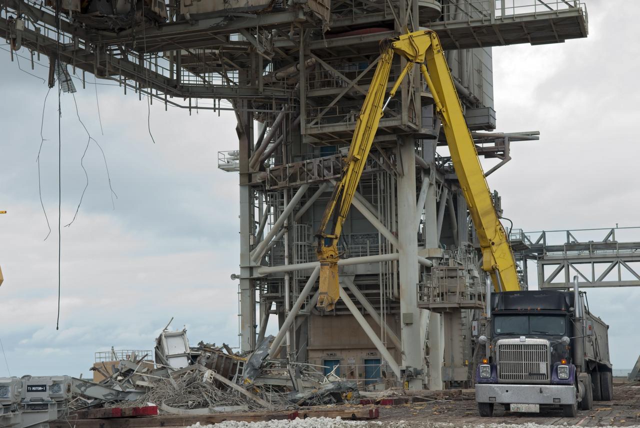 CAPE CANAVERAL, Fla. -- At NASA's Kennedy Space Center in Florida, the rotating service structure (RSS) on Launch Pad 39B is being dismantled. Sand, reinforcing steel and large wooden mats were put down under the RSS to protect the structure's concrete from falling debris during deconstruction.          Starting in 2009, the structure at the pad was no longer needed for NASA's Space Shuttle Program, so it is being restructured for future use. The new design will feature a "clean pad" for rockets to come with their own launcher, making it more versatile for a number of vehicles. The new lightning protection system, consisting of three lightning towers and a wire catenary system will remain. Photo credit: NASA/Jim Grossmann