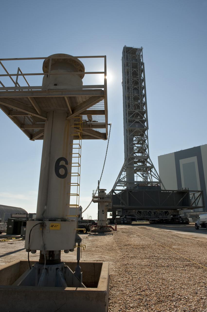 CAPE CANAVERAL, Fla. -- At NASA's Kennedy Space Center in Florida, a crawler-transporter moves NASA's new mobile launcher (ML) support structure from a construction site, north of the Vehicle Assembly Building (right), to the Mobile Launcher east park site. The base of the launcher is lighter than space shuttle mobile launcher platforms so the crawler-transporter can pick up the heavier load of the tower and a taller rocket. Once there, the ML can be outfitted with ground support equipment, such as umbilicals and access arms, for future rocket launches. It took about two years to construct the 355-foot-tall structure, which will support NASA's future human spaceflight program. Photo credit: NASA/Tony Gray
