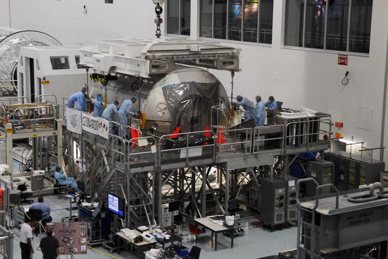 CAPE CANAVERAL, Fla. -- In the Space Station Processing Facility at NASA's Kennedy Space Center in Florida, technicians connect an overhead crane to the Permanent Multipurpose Module, or PMM, for its transfer into a payload canister.        The canister will then be transported to Launch Pad 39A and installed into space shuttle Discovery's payload bay. Discovery and its STS-133 crew will deliver the PMM, packed with supplies and critical spare parts, as well as Robonaut 2, the dexterous humanoid astronaut helper, to the International Space Station. Launch is targeted for 4:40 p.m. EDT, Nov. 1. Photo credit: NASA/Cory Huston