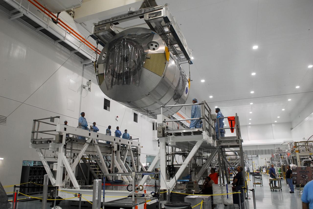 CAPE CANAVERAL, Fla. -- In the Space Station Processing Facility at NASA's Kennedy Space Center in Florida, technicians monitor the progress of the Permanent Multipurpose Module, or PMM, as it is being transferred by overhead crane towards a payload canister.        The canister will then be transported to Launch Pad 39A and installed into space shuttle Discovery's payload bay. Discovery and its STS-133 crew will deliver the PMM, packed with supplies and critical spare parts, as well as Robonaut 2, the dexterous humanoid astronaut helper, to the International Space Station. Launch is targeted for 4:40 p.m. EDT, Nov. 1. Photo credit: NASA/Cory Huston