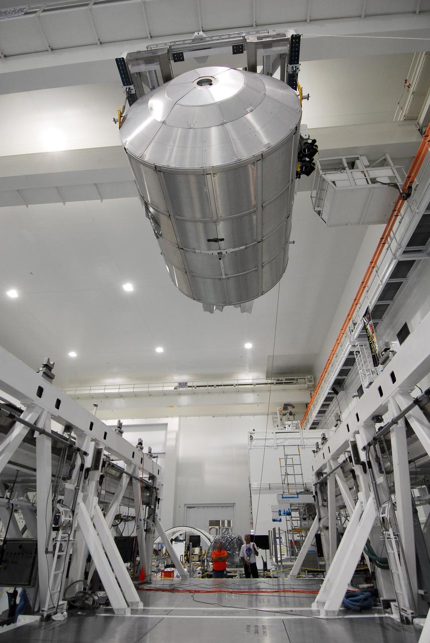 CAPE CANAVERAL, Fla. -- In the Space Station Processing Facility at NASA's Kennedy Space Center in Florida, workers guide the Permanent Multipurpose Module, or PMM, as it is being transferred by overhead crane towards a payload canister.        The canister will then be transported to Launch Pad 39A and installed into space shuttle Discovery's payload bay. Discovery and its STS-133 crew will deliver the PMM, packed with supplies and critical spare parts, as well as Robonaut 2, the dexterous humanoid astronaut helper, to the International Space Station. Launch is targeted for 4:40 p.m. EDT, Nov. 1. Photo credit: NASA/Cory Huston