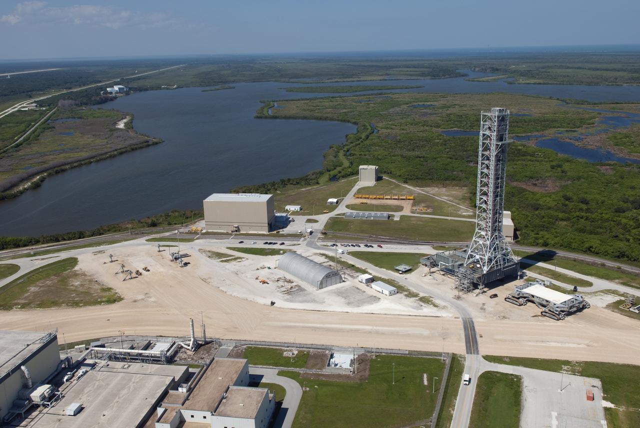 CAPE CANAVERAL, Fla. -- At NASA's Kennedy Space Center in Florida, this view of a crawler-transporter after moving NASA's new mobile launcher (ML) support structure from a construction site, north of the Vehicle Assembly Building (VAB), to the Mobile Launcher east park site is taken from the roof of the VAB. The base of the launcher is lighter than space shuttle mobile launcher platforms so the crawler-transporter can pick up the heavier load of the tower and a taller rocket. Once there, the ML can be outfitted with ground support equipment, such as umbilicals and access arms, for future rocket launches. It took about two years to construct the 355-foot-tall structure, which will support NASA's future human spaceflight program. Photo credit: NASA/Jim Grossmann