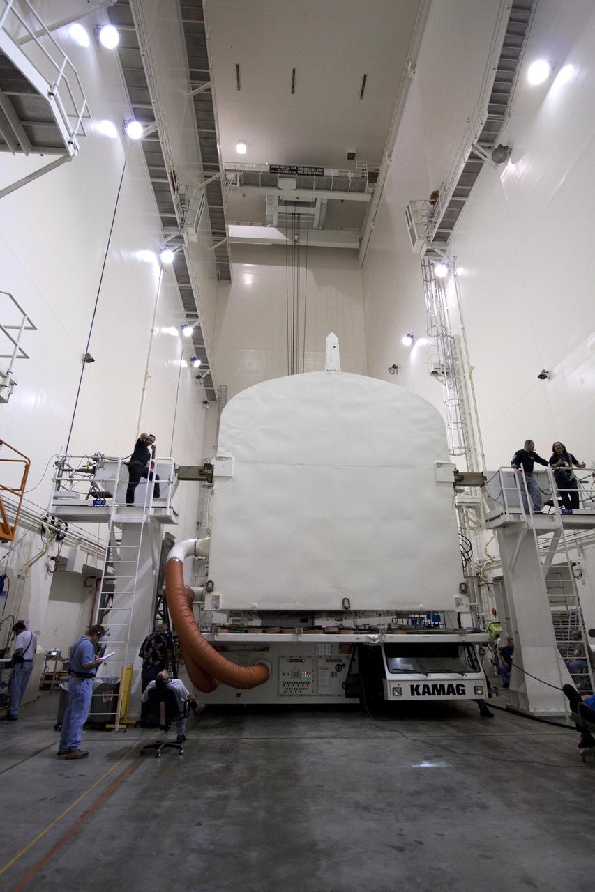 CAPE CANAVERAL, Fla. -- In the Canister Rotation Facility at NASA's Kennedy Space Center in Florida, workers are preparing the payload canister for its rotation into a vertical position.        The canister will then be delivered to Launch Pad 39A, lifted into the rotating service structure where the module will be moved into the clean room before it is installed into space shuttle Discovery's payload bay. Discovery and its STS-133 crew will deliver the PMM, packed with supplies and critical spare parts, as well as Robonaut 2, the dexterous humanoid astronaut helper, to the International Space Station. Launch is targeted for 4:40 p.m. EDT, Nov. 1. Photo credit: NASA/Jack Pfaller