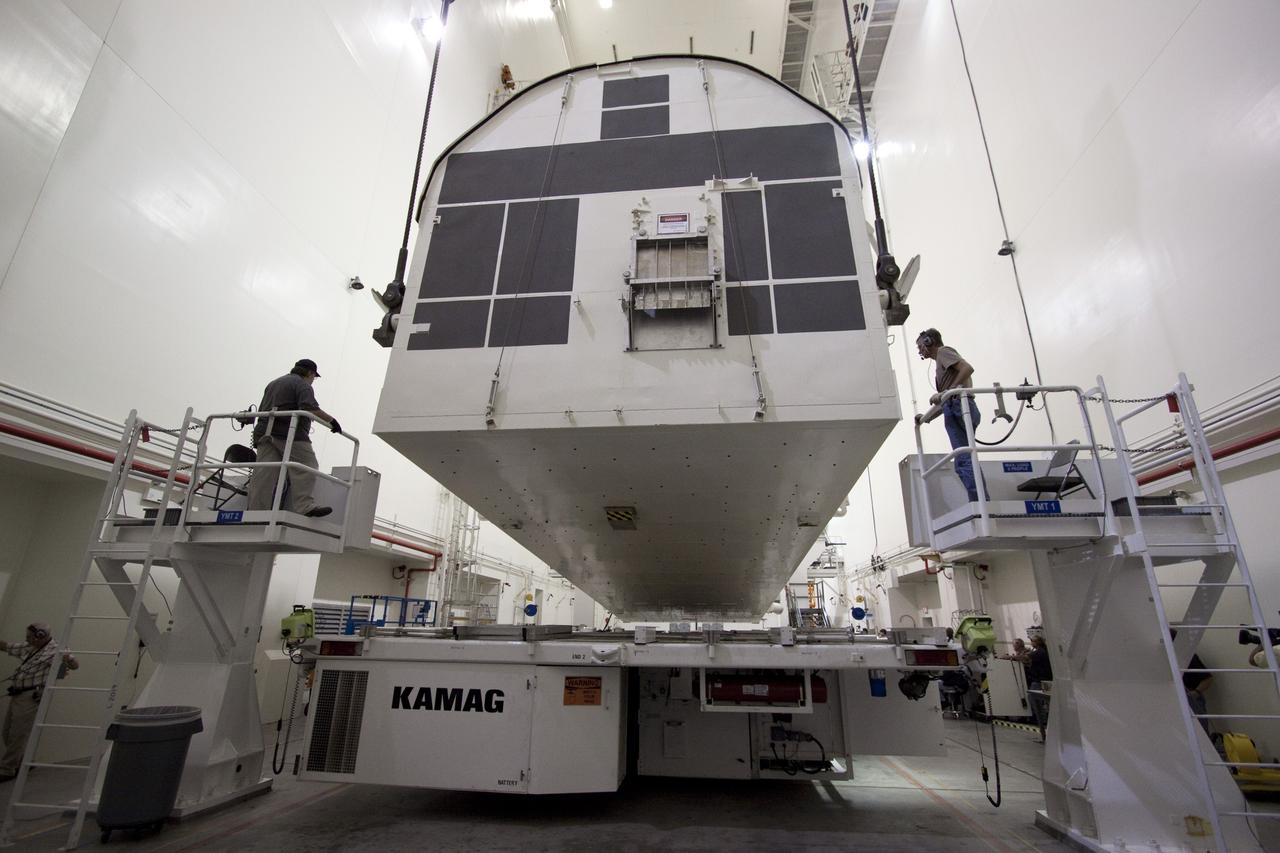 CAPE CANAVERAL, Fla. -- In the Canister Rotation Facility at NASA's Kennedy Space Center in Florida, workers monitor the progress of the payload canister as an overhead crane rotates it into a vertical position.        The canister will then be delivered to Launch Pad 39A, lifted into the rotating service structure where the module will be moved into the clean room before it is installed into space shuttle Discovery's payload bay. Discovery and its STS-133 crew will deliver the PMM, packed with supplies and critical spare parts, as well as Robonaut 2, the dexterous humanoid astronaut helper, to the International Space Station. Launch is targeted for 4:40 p.m. EDT, Nov. 1. Photo credit: NASA/Jack Pfaller