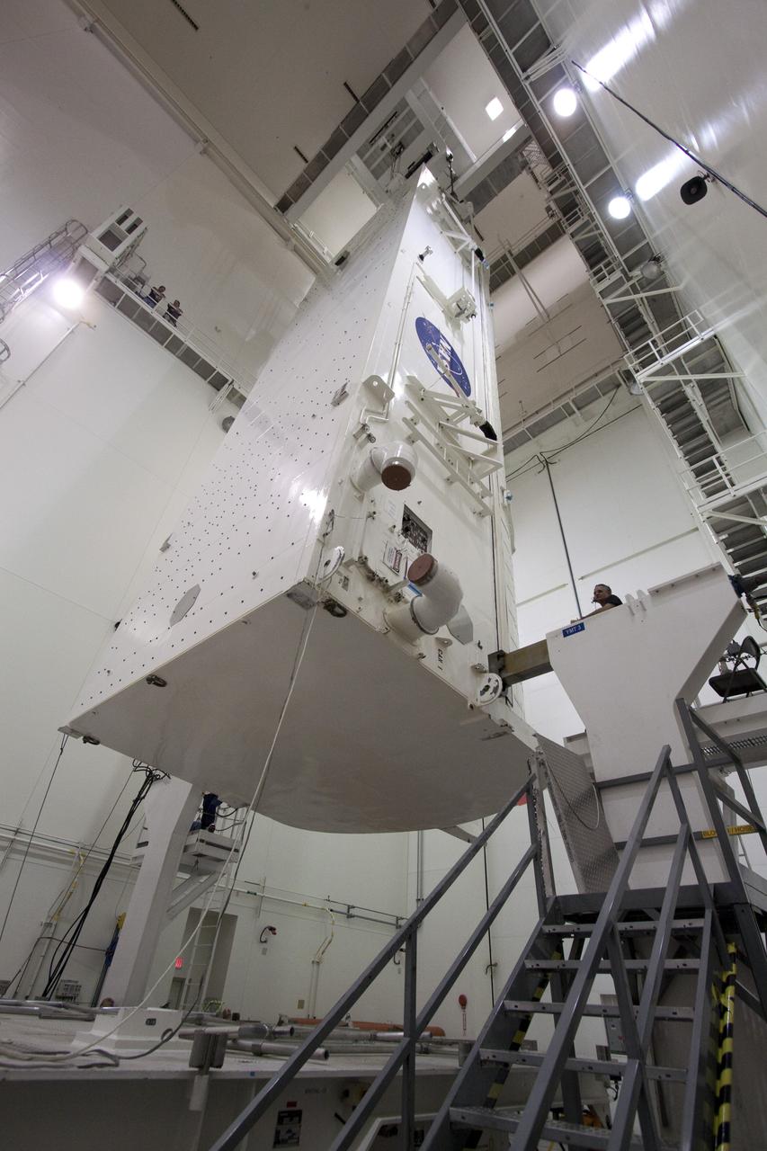 CAPE CANAVERAL, Fla. -- In the Canister Rotation Facility at NASA's Kennedy Space Center in Florida, workers monitor the progress of the payload canister as an overhead crane lifts it into a vertical position.        The canister will then be delivered to Launch Pad 39A, lifted into the rotating service structure where the module will be moved into the clean room before it is installed into space shuttle Discovery's payload bay. Discovery and its STS-133 crew will deliver the PMM, packed with supplies and critical spare parts, as well as Robonaut 2, the dexterous humanoid astronaut helper, to the International Space Station. Launch is targeted for 4:40 p.m. EDT, Nov. 1. Photo credit: NASA/Jack Pfaller