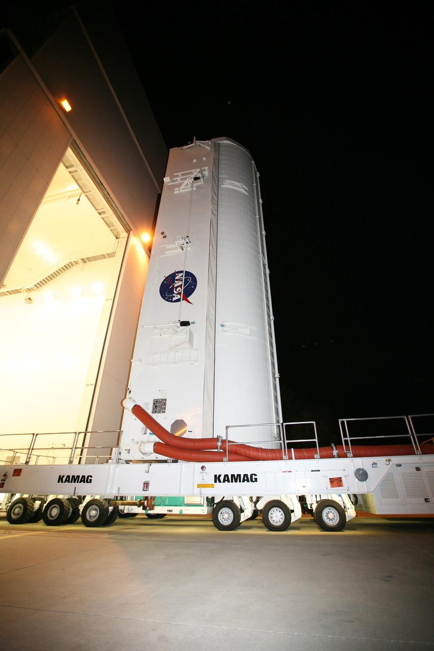 CAPE CANAVERAL, Fla. -- At NASA's Kennedy Space Center in Florida, the STS-133 payload canister leaves the Canister Rotation Facility on a transport vehicle headed for Launch Pad 39A where it will be lifted into the rotating service structure.          The payload then will be moved into space shuttle Discovery's payload bay. Discovery and its STS-133 crew will deliver the Permanent Multipurpose Module, packed with supplies and critical spare parts, as well as Robonaut 2, the dexterous humanoid astronaut helper, to the International Space Station. Launch is targeted for 4:40 p.m. EDT, Nov. 1. Photo credit: NASA/Amanda Diller