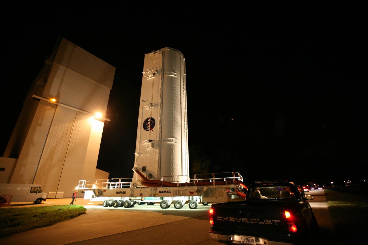 CAPE CANAVERAL, Fla. -- At NASA's Kennedy Space Center in Florida, the STS-133 payload canister leaves the Canister Rotation Facility on a transport vehicle headed for Launch Pad 39A where it will be lifted into the rotating service structure.        The payload then will be moved into space shuttle Discovery's payload bay. Discovery and its STS-133 crew will deliver the Permanent Multipurpose Module, packed with supplies and critical spare parts, as well as Robonaut 2, the dexterous humanoid astronaut helper, to the International Space Station. Launch is targeted for 4:40 p.m. EDT, Nov. 1. Photo credit: NASA/Amanda Diller