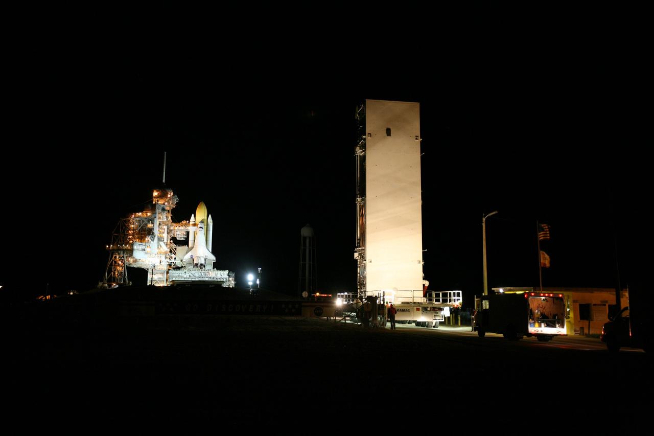 CAPE CANAVERAL, Fla. -- At NASA's Kennedy Space Center in Florida, the STS-133 payload canister approaches Launch Pad 39A where it will be lifted into the rotating service structure.        The payload then will be moved into space shuttle Discovery's payload bay. Discovery and its STS-133 crew will deliver the Permanent Multipurpose Module, packed with supplies and critical spare parts, as well as Robonaut 2, the dexterous humanoid astronaut helper, to the International Space Station. Launch is targeted for 4:40 p.m. EDT, Nov. 1. Photo credit: NASA/Amanda Diller