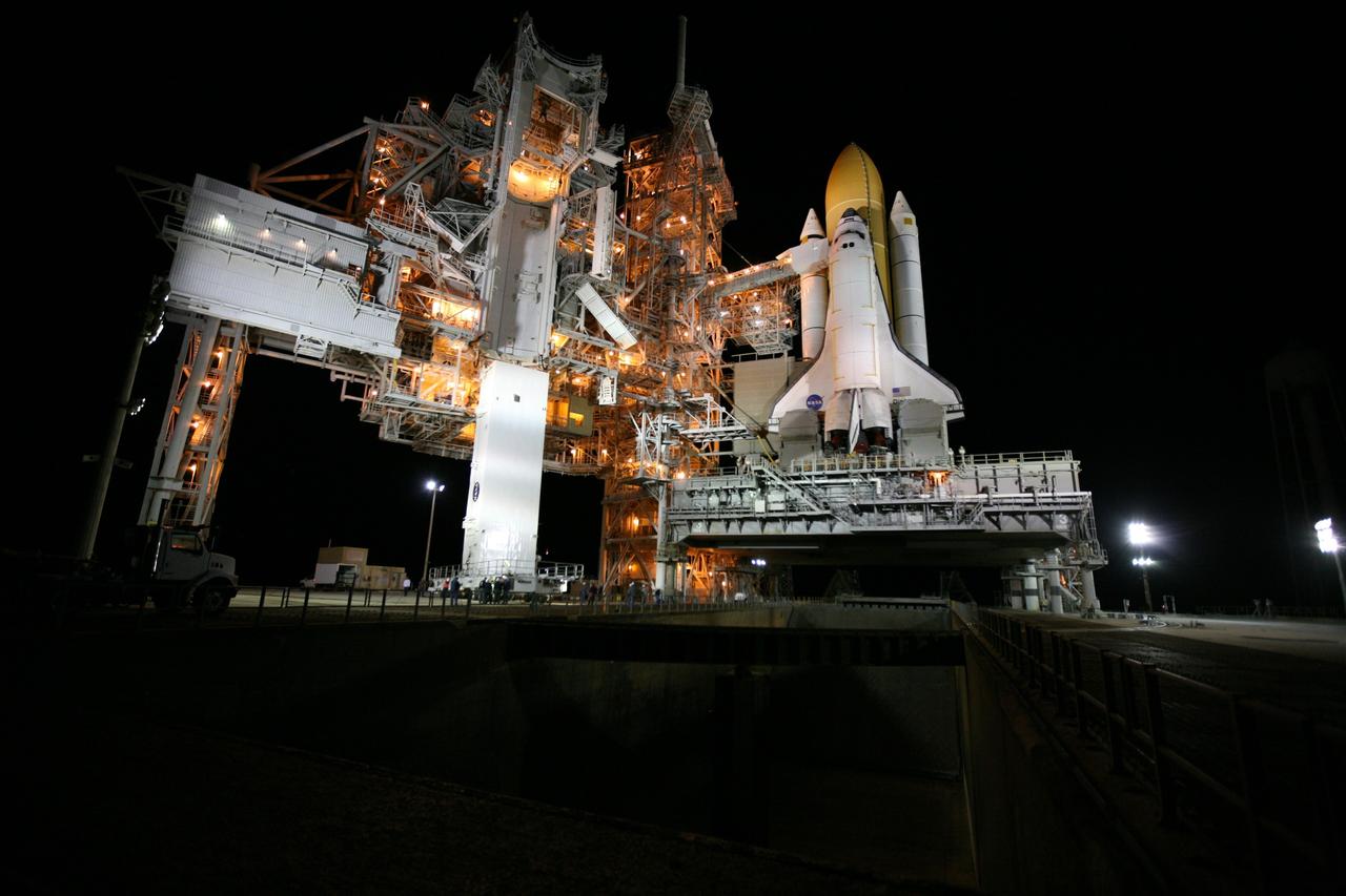 CAPE CANAVERAL, Fla. -- At NASA's Kennedy Space Center in Florida, workers monitor the arrival of the STS-133 payload canister to Launch Pad 39A where it will be lifted into the rotating service structure.        The payload then will be moved into space shuttle Discovery's payload bay. Discovery and its STS-133 crew will deliver the Permanent Multipurpose Module, packed with supplies and critical spare parts, as well as Robonaut 2, the dexterous humanoid astronaut helper, to the International Space Station. Launch is targeted for 4:40 p.m. EDT, Nov. 1. Photo credit: NASA/Amanda Diller
