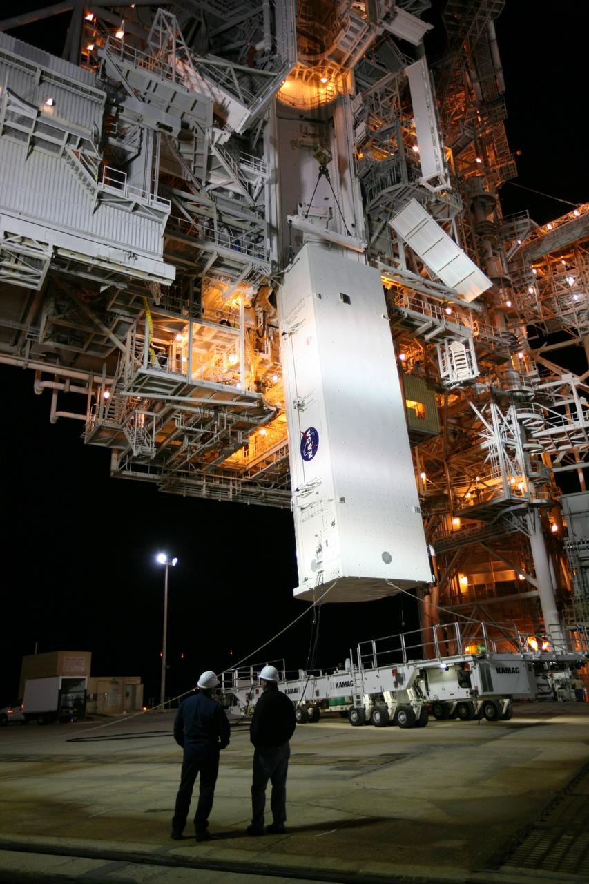 CAPE CANAVERAL, Fla. -- At NASA's Kennedy Space Center in Florida, workers begin the process of lifting the STS-133 payload canister off its transport vehicle toward the rotating service structure on Launch Pad 39A.        The payload then will be moved into space shuttle Discovery's payload bay. Discovery and its STS-133 crew will deliver the Permanent Multipurpose Module, packed with supplies and critical spare parts, as well as Robonaut 2, the dexterous humanoid astronaut helper, to the International Space Station. Launch is targeted for 4:40 p.m. EDT, Nov. 1. Photo credit: NASA/Amanda Diller
